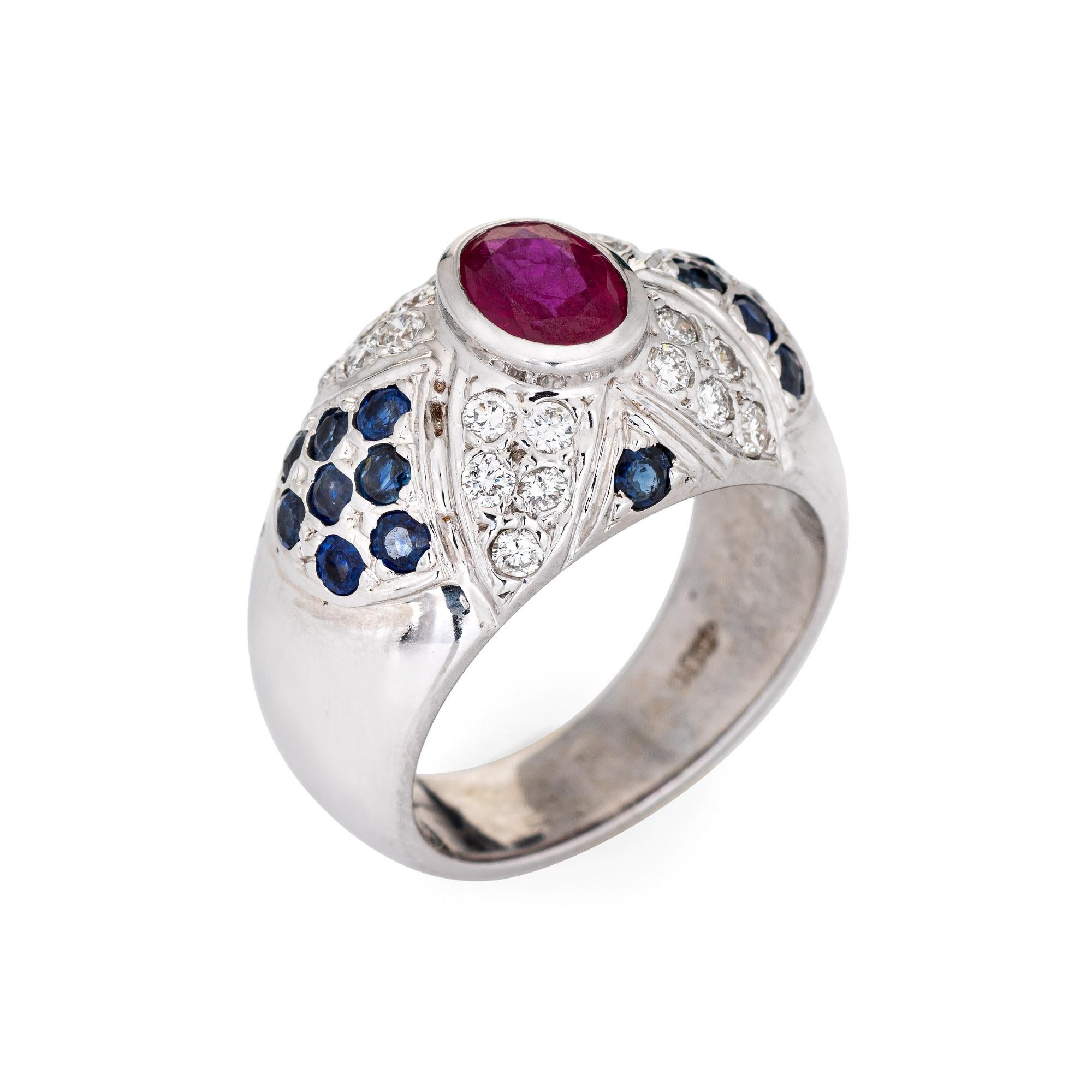 The wide band dome ring is set with a rich red ruby to the center, accented with sapphires and diamonds. The ring is great worn alone or stacked with your fine jewelry from any era. The low rise ring (6.5mm - 0.25 inches) sits comfortably on the