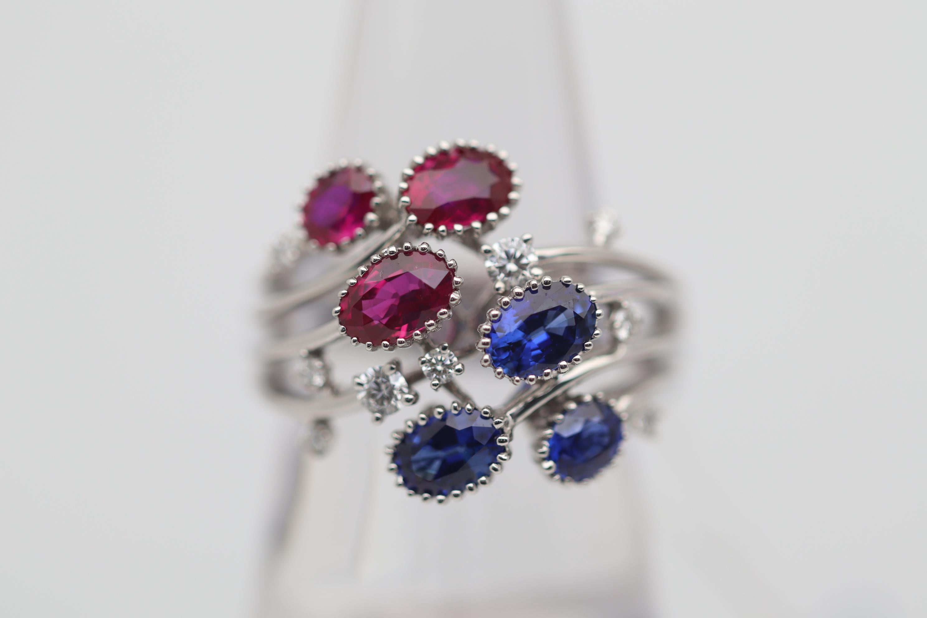 One of our new favorite pieces in our collection! This breathtaking floral ring features 3 vivid red gem rubies and 3 equally as beautiful vivid royal blue sapphires. They weigh a total of 1.62 carats and 1.49 carats respectively. Diamonds, 0.26