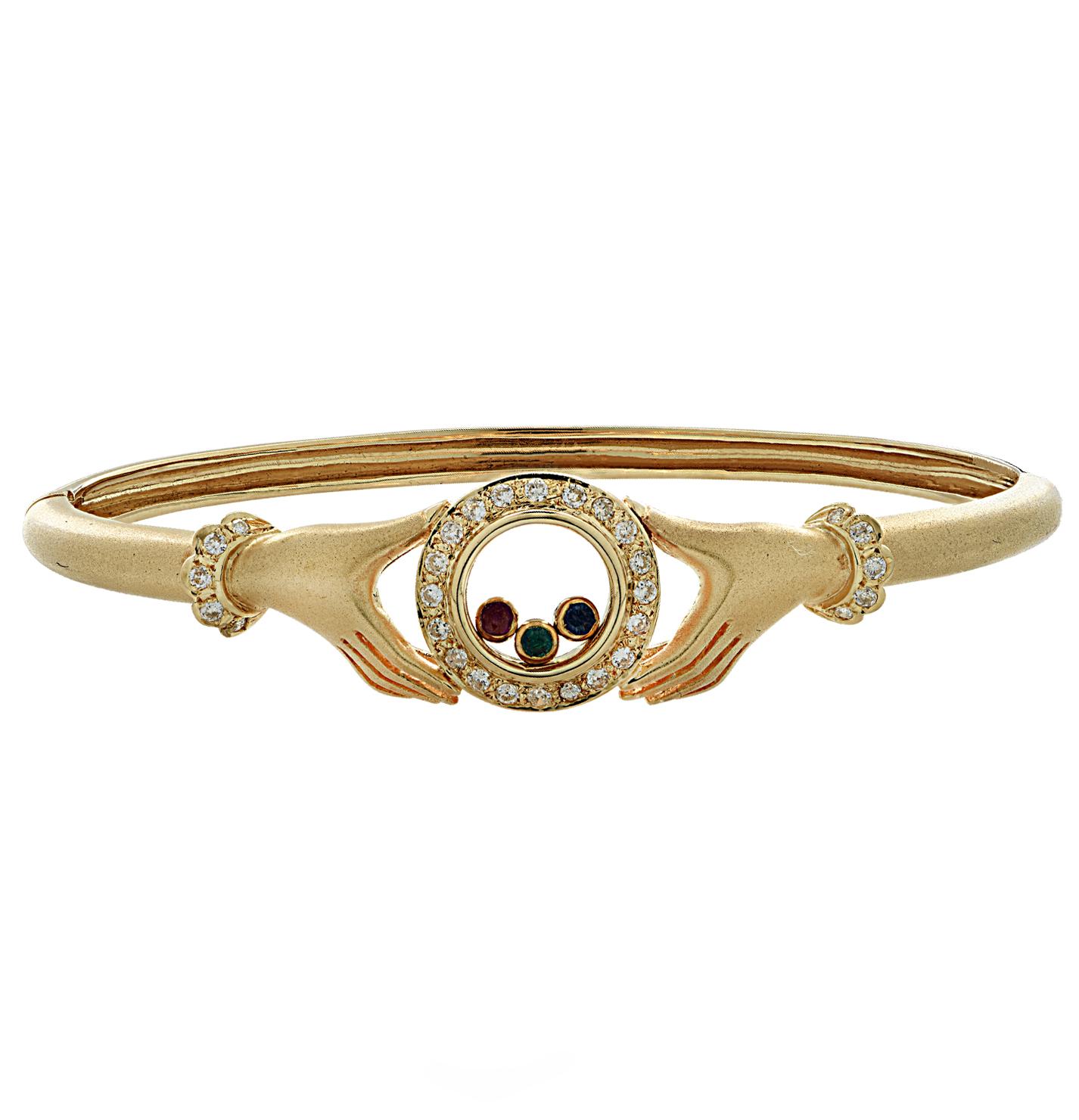 Gorgeous bangle bracelet crafted in 18 karat yellow gold, featuring 30 round brilliant cut diamonds weighing approximately .40 carats total, G color, VS-SI clarity and one emerald, one sapphire and one ruby weighing approximately .0.09 carats total.