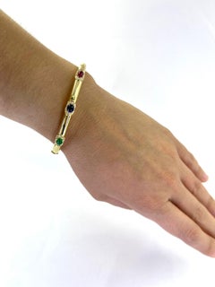 Ruby, Sapphire, Emerald, and Diamond Hinged Oval Bangle in Yellow Gold
