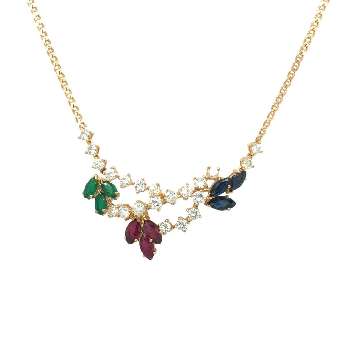 This stunning leaf necklace is a beautiful combination of modern elegance and natural inspiration. Crafted in 18K yellow gold, the intricate vine motif design in the center of the necklace showcases marquise-shaped gemstone leaves in Ruby, Emerald