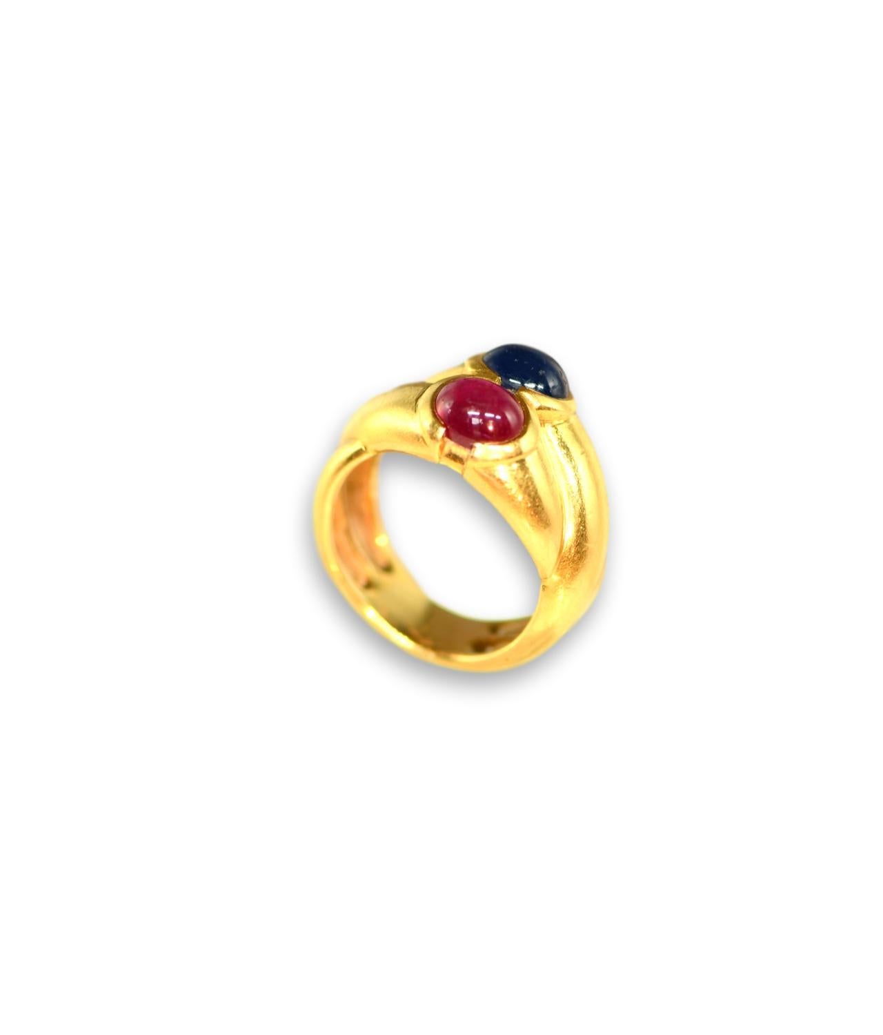 Beautiful 18k yellow gold bypass ring, featuring 7mm x 6 x 4mm sapphire and 7mm x 6.2 x 4mm ruby, both cabochons. Timeless, classy and wearable, the ring is a great addition to your jewelry collection. 

Ring size is 7 (it is re-sizable)
Stamped