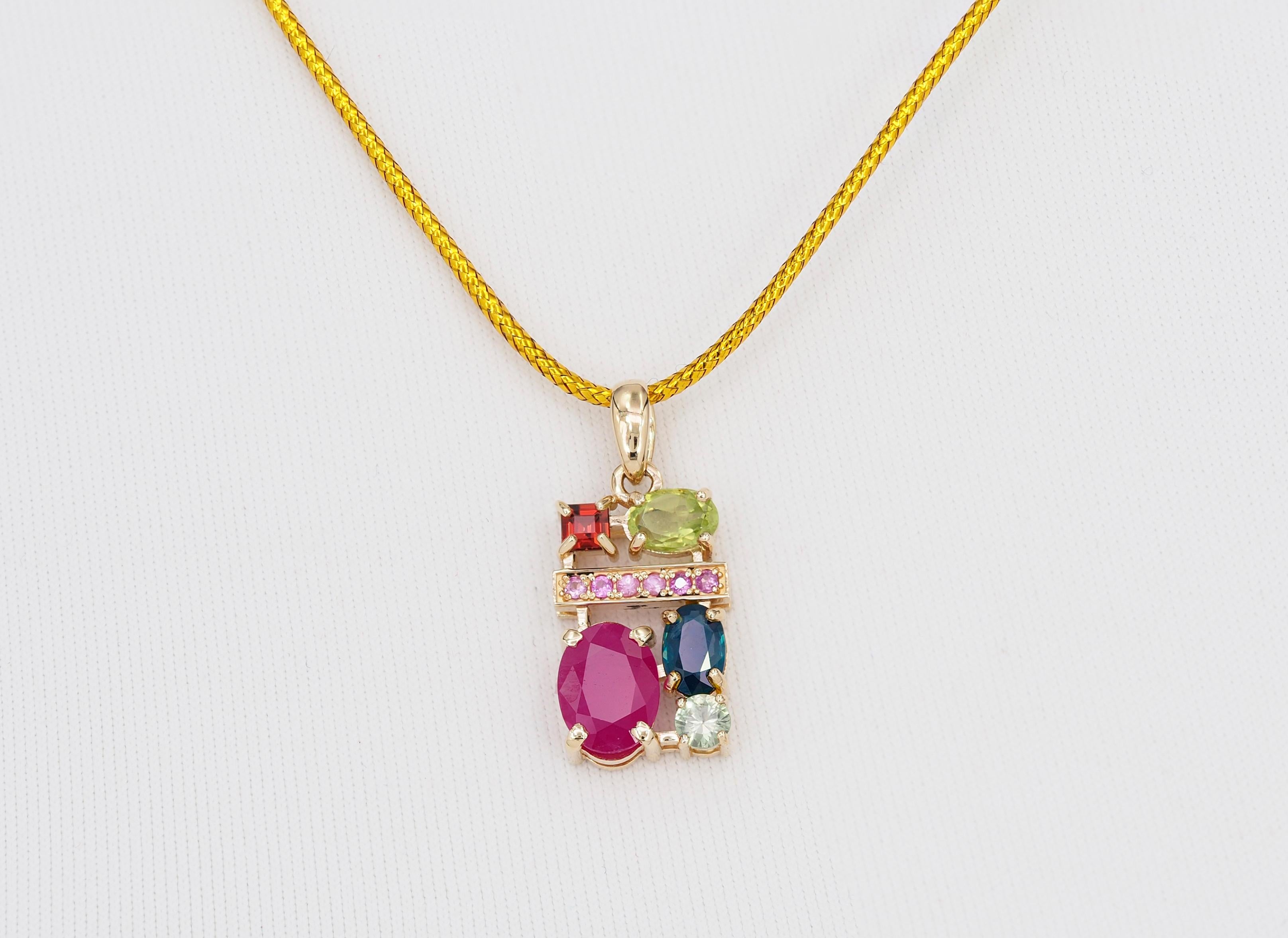 Ruby, sapphire, peridot, tourmaline, garnet and side pink sapphires vintage pendant.

Metal: 14k gold
WEight - 2.85 gr
Pendant size - 26x10.6 mm

Gemstones:
Ruby - 1.3 ct, red color, transparent, oval cut
Sapphire - 0.8 ct, blue color, transparent,