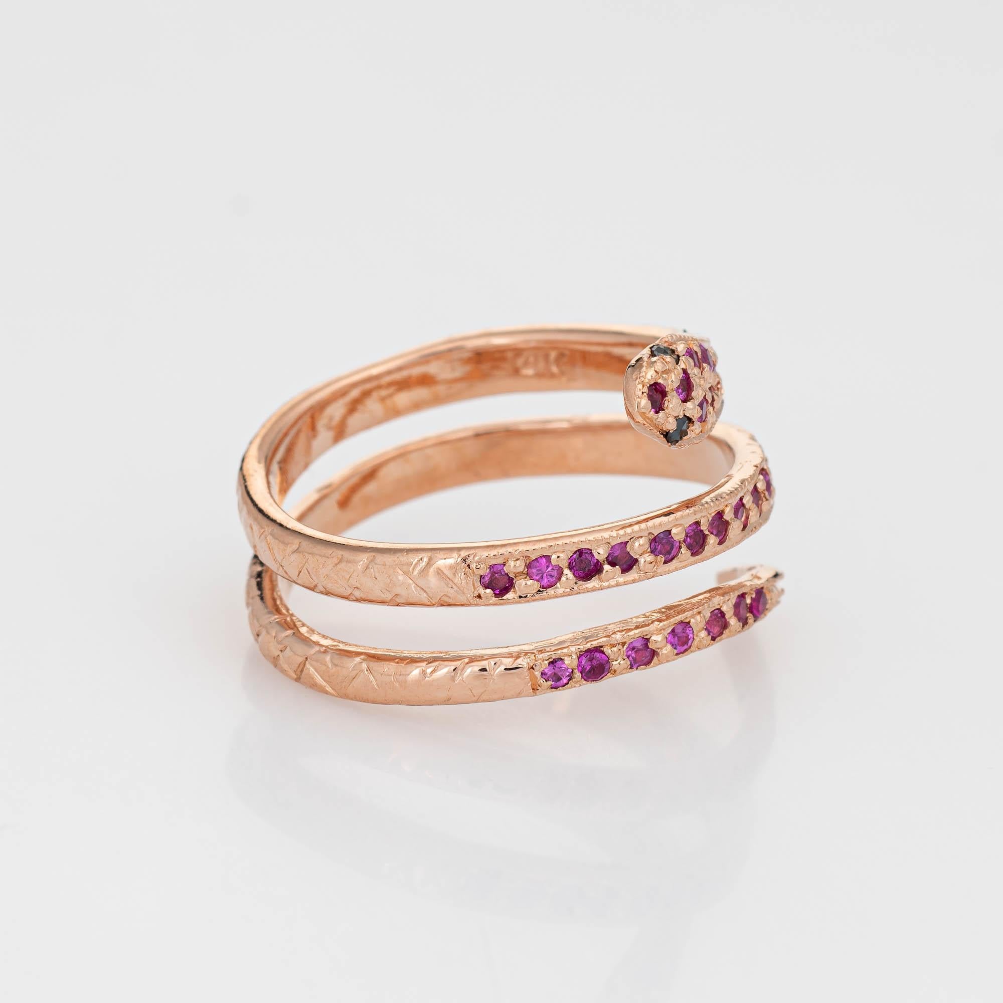 Finely detailed vintage snake ring, crafted in 14 karat rose gold. 

Rubies total an estimated 0.36 carats. Two estimated 0.01 carat black diamonds are set into the eyes.     

For centuries the snake has represented eternal love and faithfulness.