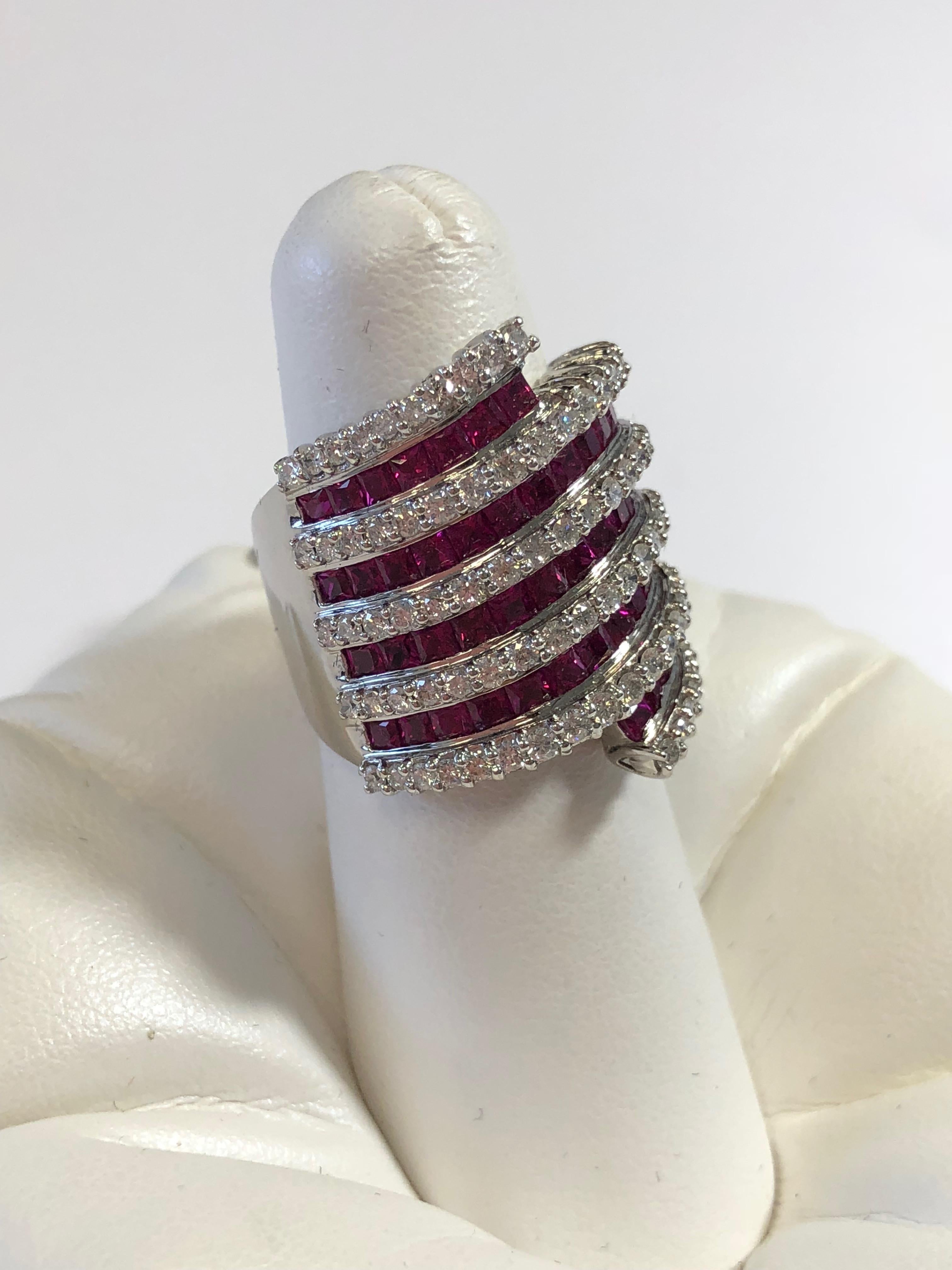 Stunning deep red ruby squares weighting 4 carats with 1.50 carats of good quality white diamonds in a 18k white gold size 6.5 mounting.  With alternating lines of ruby and diamonds, this ring has a beautiful contrast design.  The deep red hue of