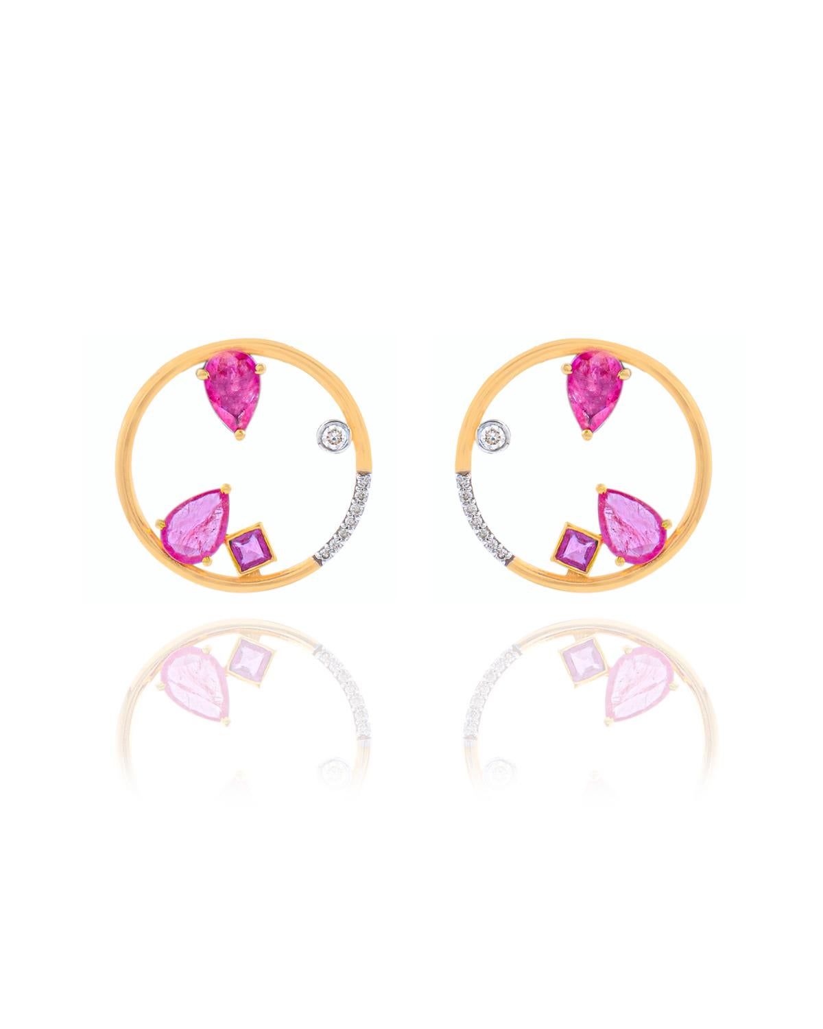 These earrings are made with Ruby gemstones and diamond. They are set in 14K gold. Shine all day long in this delicate pair of stud earrings. Perfect for gifting, they twinkle with timeless elegance. Easy to mix and match with other jewellery