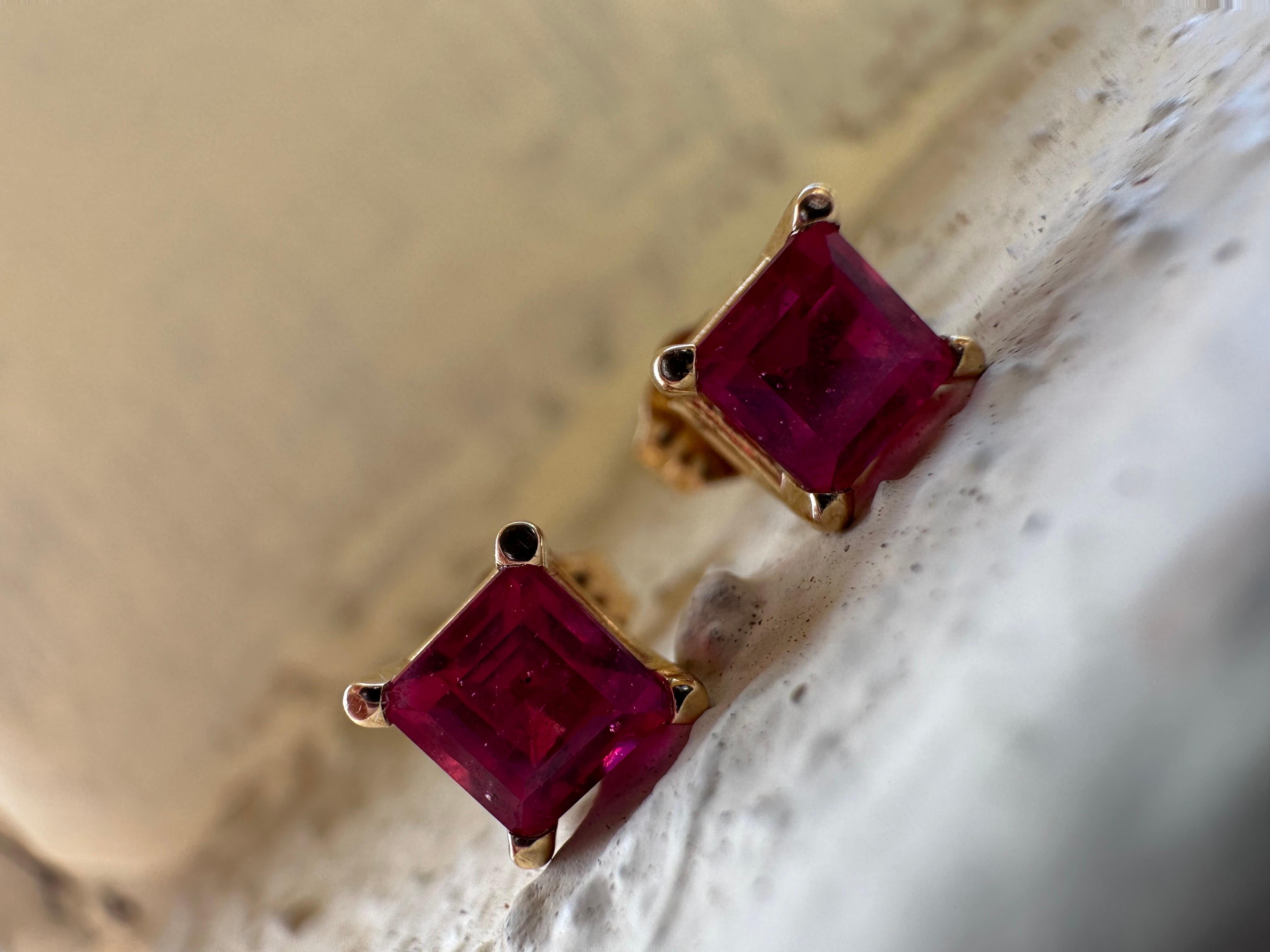 Ruby studs in 14KT rose gold, beautiful finished on the studs.
Metal Type: 14KT
Natural Ruby(s):
Color: Pinkish Red
Cut:Princess
Carat: 1.00ct (5mm)
Clarity: Slightly Included (clarity enhanced)

Certificate of authenticity comes with