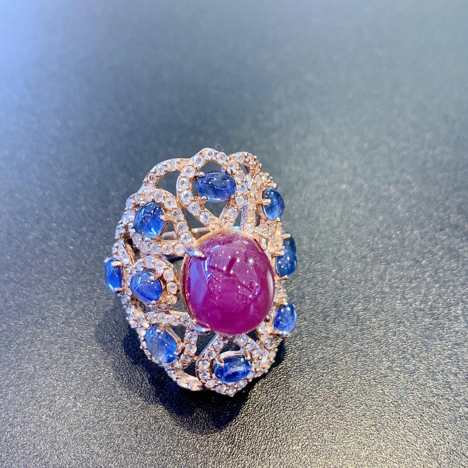 Bochic Ruby, Tanzanite & Fancy Sapphire Candy Cocktail Ring 
Red Natural Ruby
Shape -  Cabochon
6 Carats 
Oval cabochons shape tanzanites
Color - deep purple
8.5 Carats 
Round brilliant White Topaz Natural 
Cut - round brilliant
4 Carats 
22k Pink