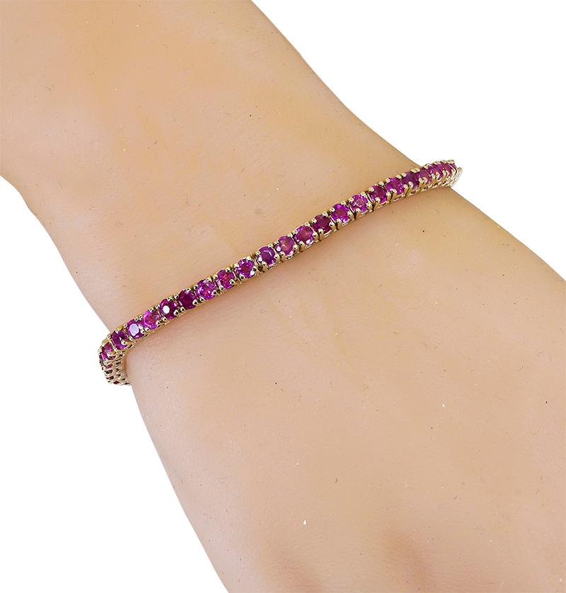 A 14K rose gold tennis bracelet, set with 54 round 3.0 mm Burma color rubies, that have a total weight of 7.19 cts. This item is part of our stackable collection, beautiful on it's own and magnificent with other bracelets from our stackable