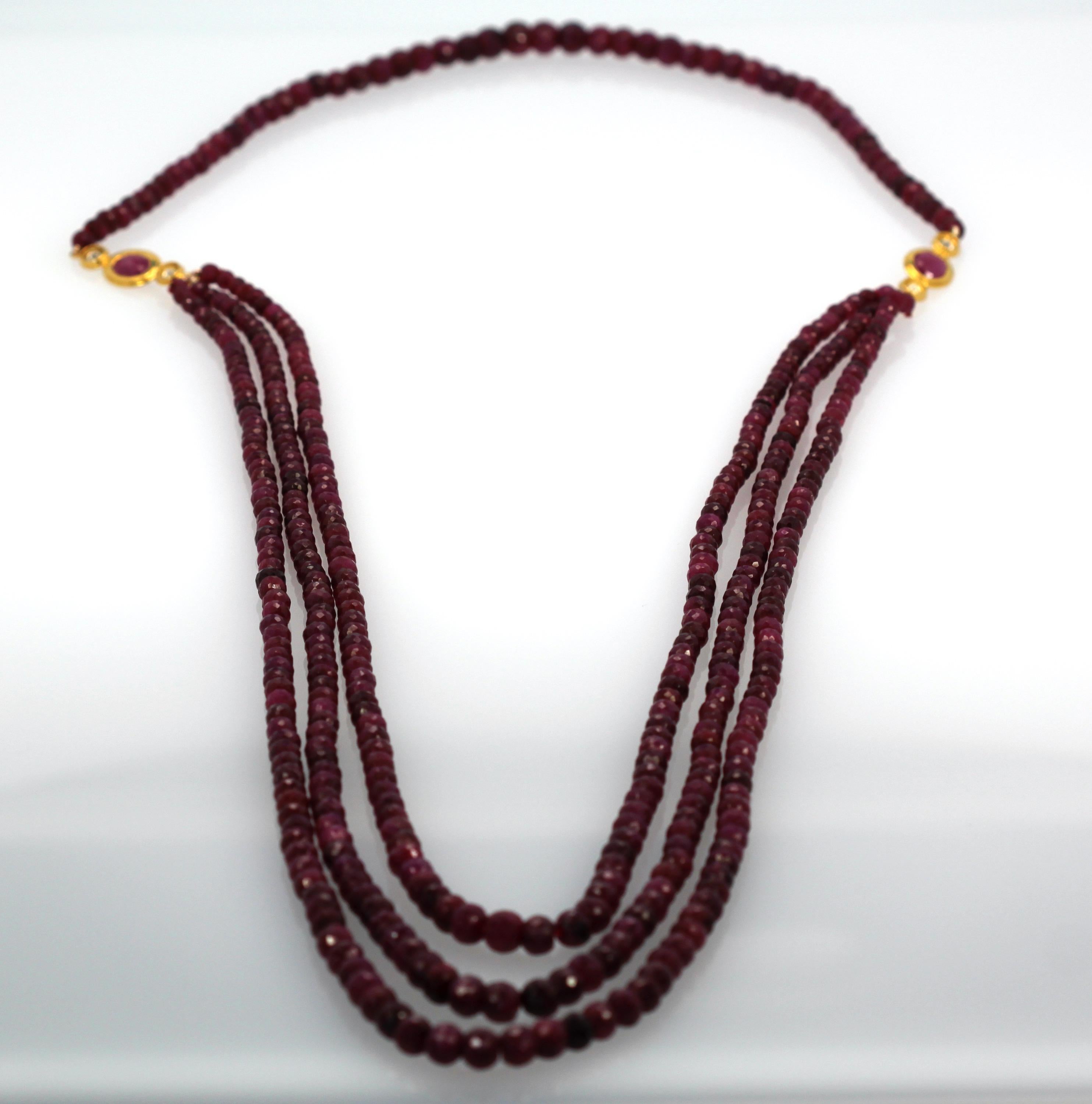 This piece will make a statement and have all eyes on you!  It features faceted Ruby beads that are a rich, deep, true ruby red with three strands in front and one strand in back. The two faceted oval rubies are approximately 1.50 carats each, and