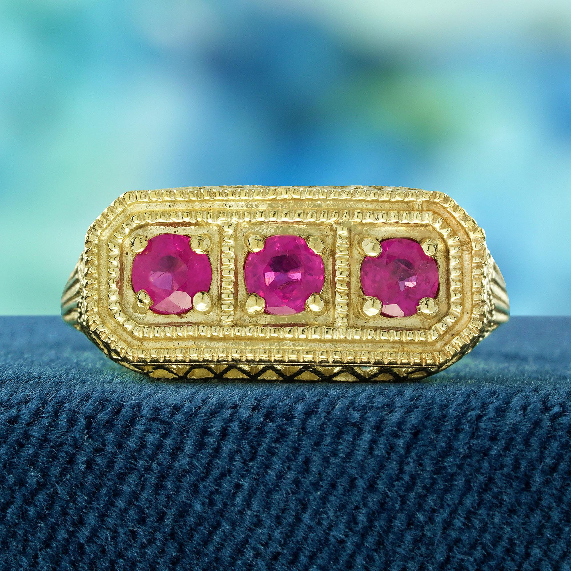 Introducing our stunning natural ruby three stone filigree ring, a truly captivating piece inspired by the elegance of the Vintage Art Deco style. Crafted in solid yellow gold, this exquisite ring showcases three vibrant rubies, each set in