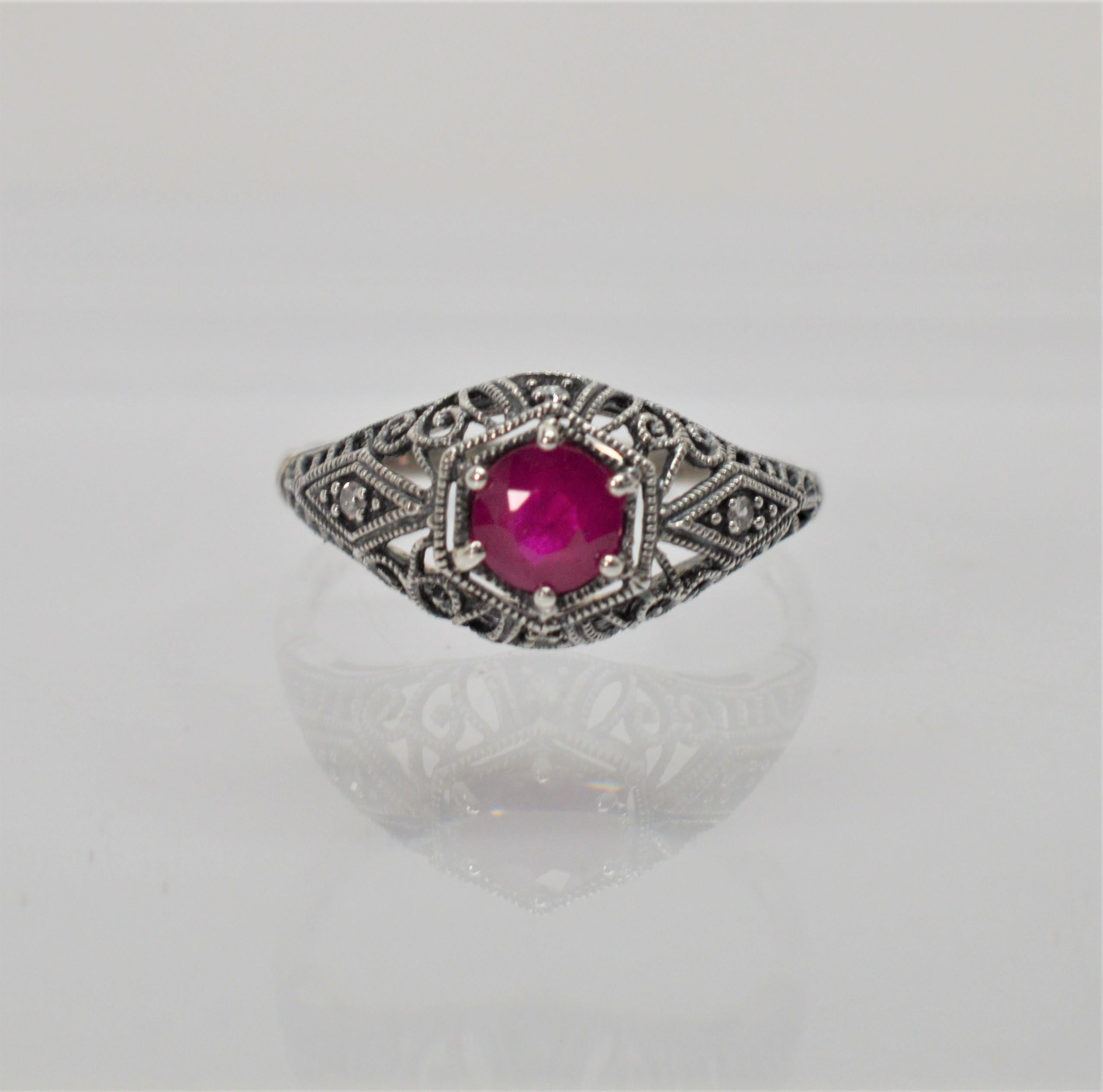 Vintage inspired design in sterling silver filigree with genuine gemstones. Enjoy this timeless design with exquisite detail reminiscent of the Art Deco Period. This sweet vintage style ring has a 2.5 carat round faceted Ruby with two diamond