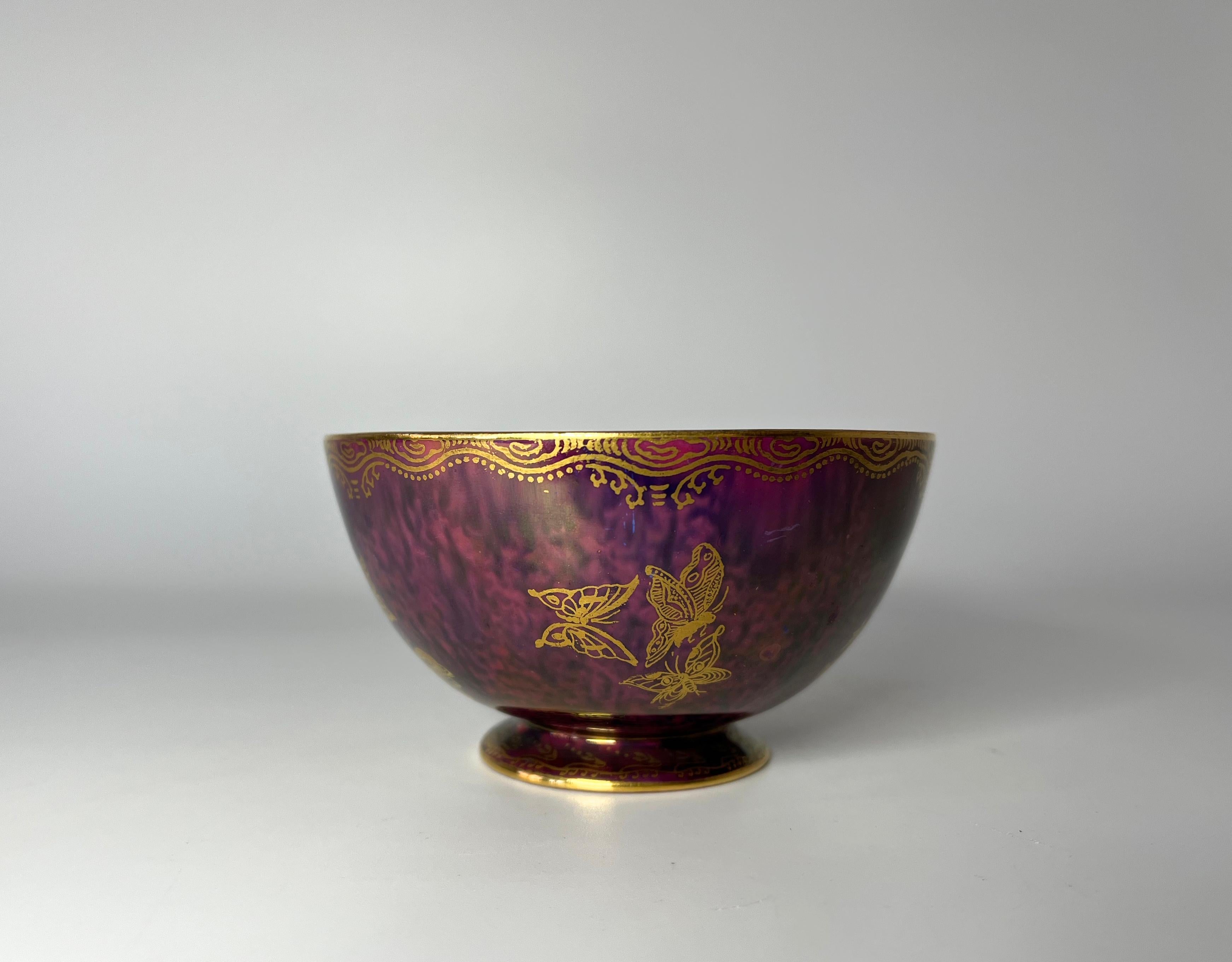 Exquisite ruby Ordinary lustre york cup by Daisy Makeig Jones for Wedgwood, England.
The interior of this delightful piece has a vibrantly coloured butterfly on a pale green mother of pearl background, with gilded interior patterning.
Rich ruby red
