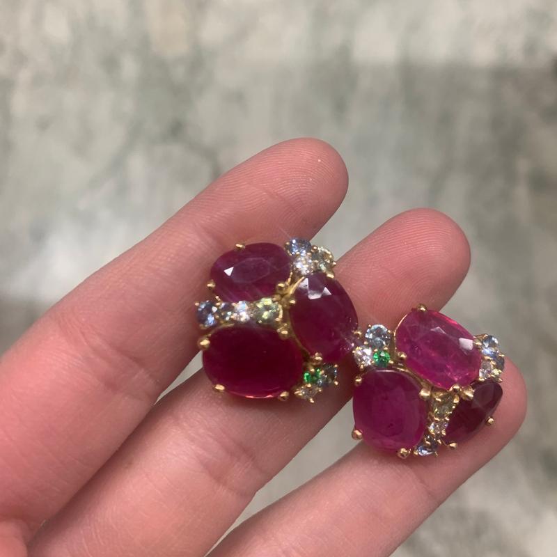 Flat hand cut rubies have been artfully set in 18kt Yellow Gold in our 150 year old workshop. Our fifth generation goldsmith has expertly placed White Diamonds, Sapphires and Tsavorites between the rich red stones to add sparkle and reflection as