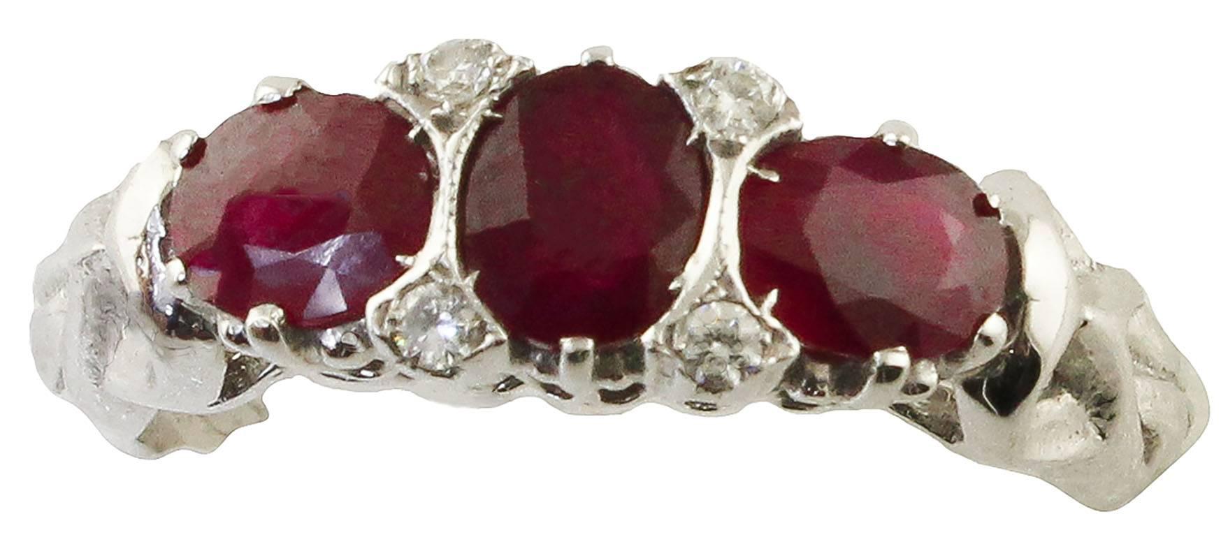 Fabulous 18 kt white gold three-stone ring with three rubies, surrounded by white diamonds that illuminate this wonderful jewel. 
Diamonds ct 0.07
Rubies 1.87 ct
Total weight g 3.70 g
Italian size 14
French Size 54
Usa Size 6.84
R.F + guuh