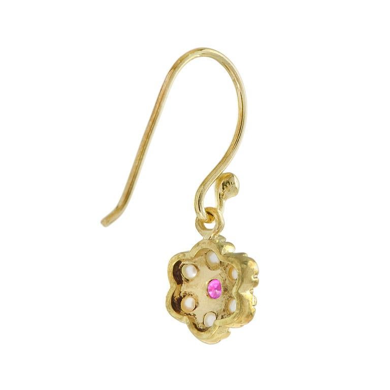 Bring a touch of a lovely floral design to your wardrobe with this pair of ruby and diamond drop earrings arranged in the shape of an antique bloom. 14K Yellow Gold. 
Information
Width: 8 mm.
Length: 22 mm.
Weight: 2.10 g. (approx. total