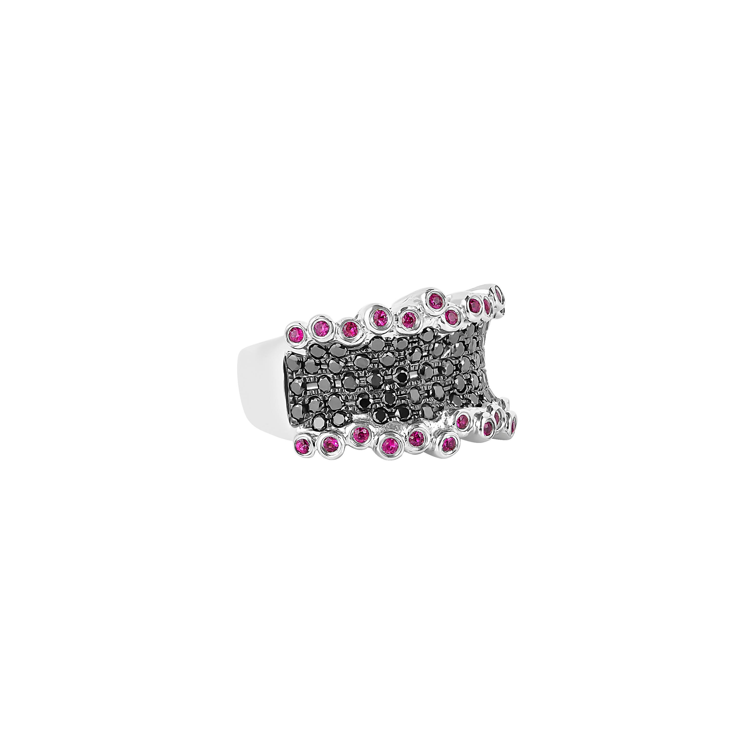 Sunita Nahata presents a collection of fancy cocktail rings with gorgeous gemstones. This ring uses a pave structure of black diamonds with architecturally aligned bezel set rubies. This unique and contrasting design presents a striking cocktail