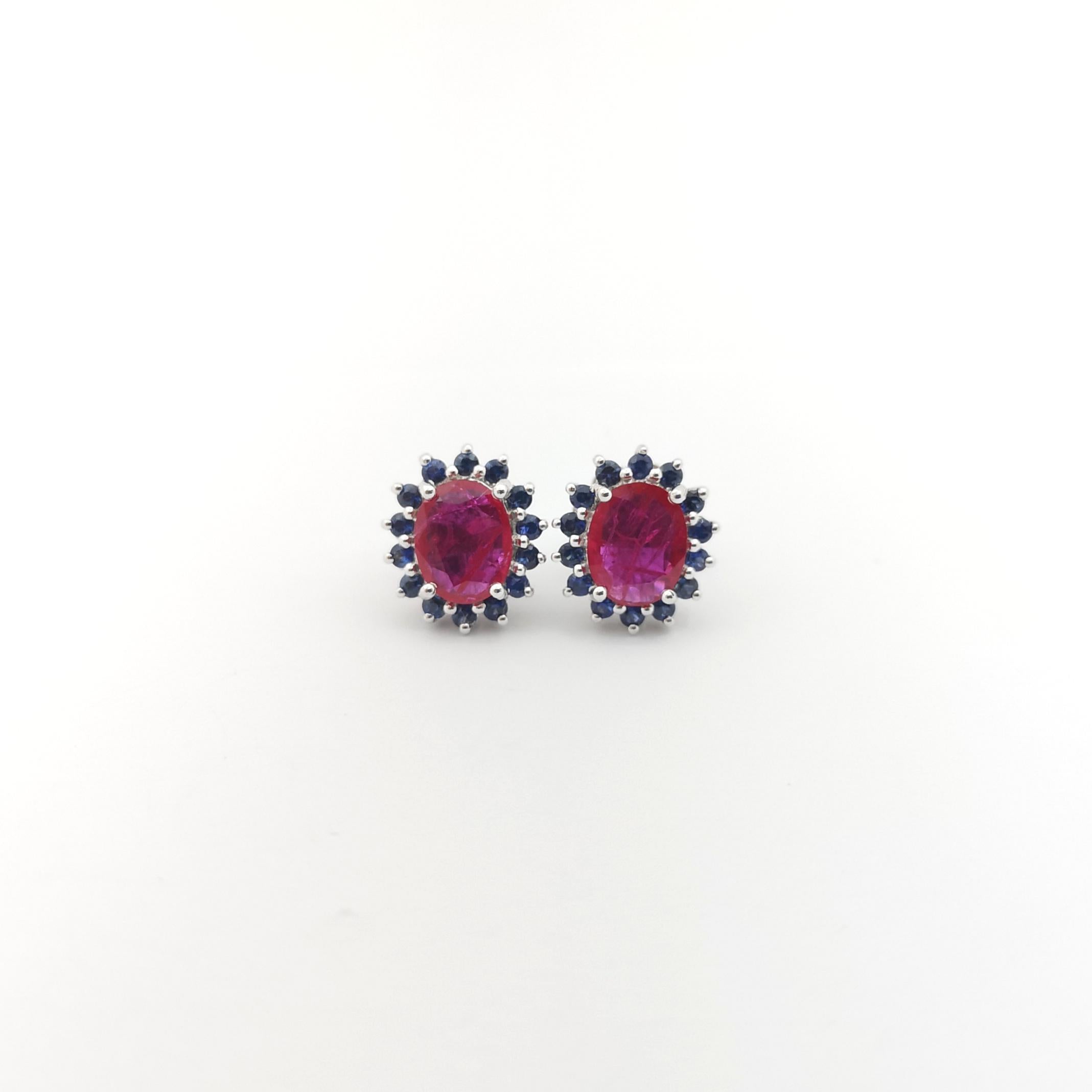 Oval Cut Ruby with Blue Sapphire Earrings set in 14K White Gold Settings For Sale