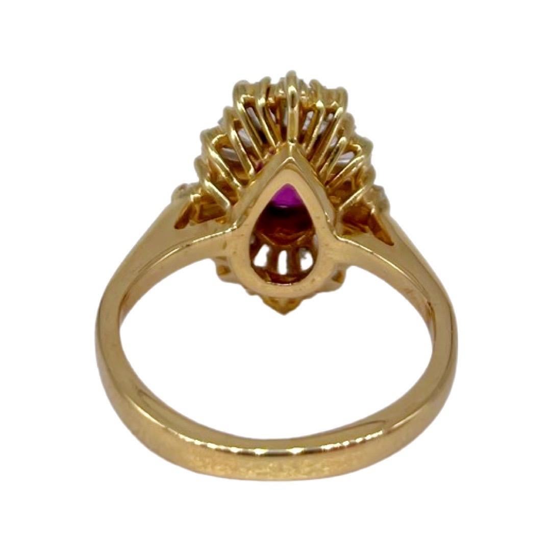 One ladies stamped Ruby with baguette Diamond Halo. (8.3mm center stone) 18k yellow gold. 