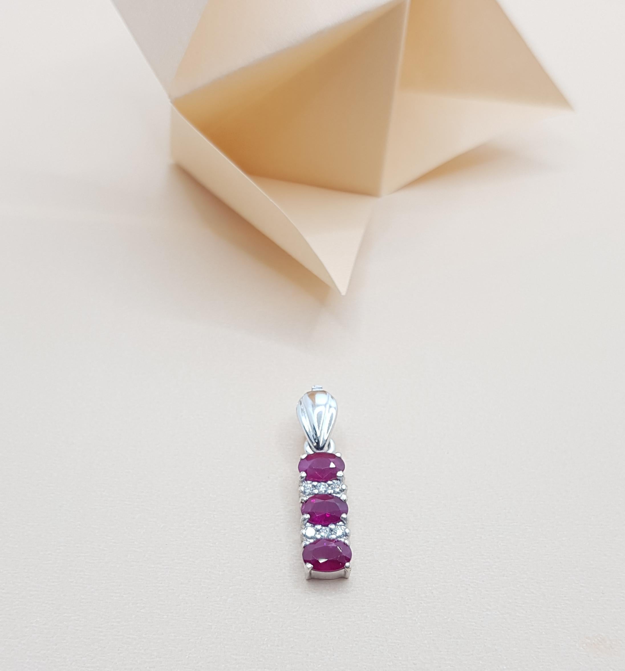 Ruby 1.74 carats with Diamond 0.11 carat Pendant set in 18 Karat White Gold Settings
(chain not included)

Width:  0.6 cm 
Length: 2.6 cm
Total Weight: 3.25 grams

