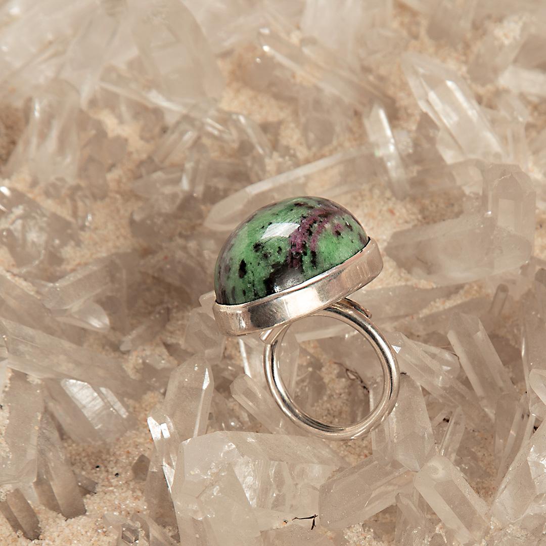 Delicate Ruby Zoisite in green, black, purple gem with sterling silver ring. A simple but exquisite solitaire design of an oval cabochon cocktail jewel.
 
This very strange and unique gem that generates such beautiful and different shades, is