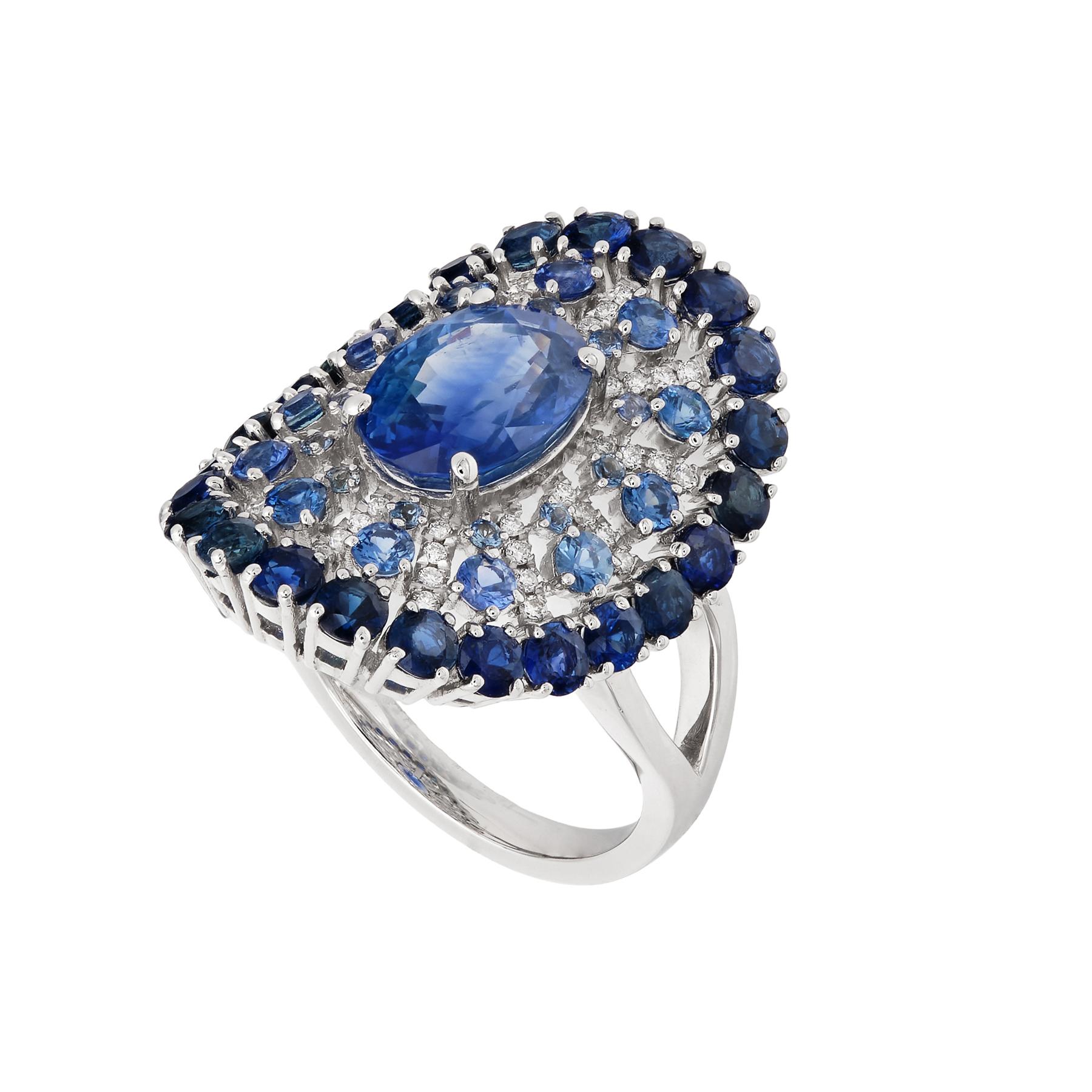 Shield cocktail ring with center oval blue sapphire, with a round diamonds and sapphires 'lace' pattern.

Ring size: 6.5 U.S.
Blue Sapphire: 5.87 ct total weight.
Diamond:  0.17 ct total weight.
All diamonds are G-H/SI stones.