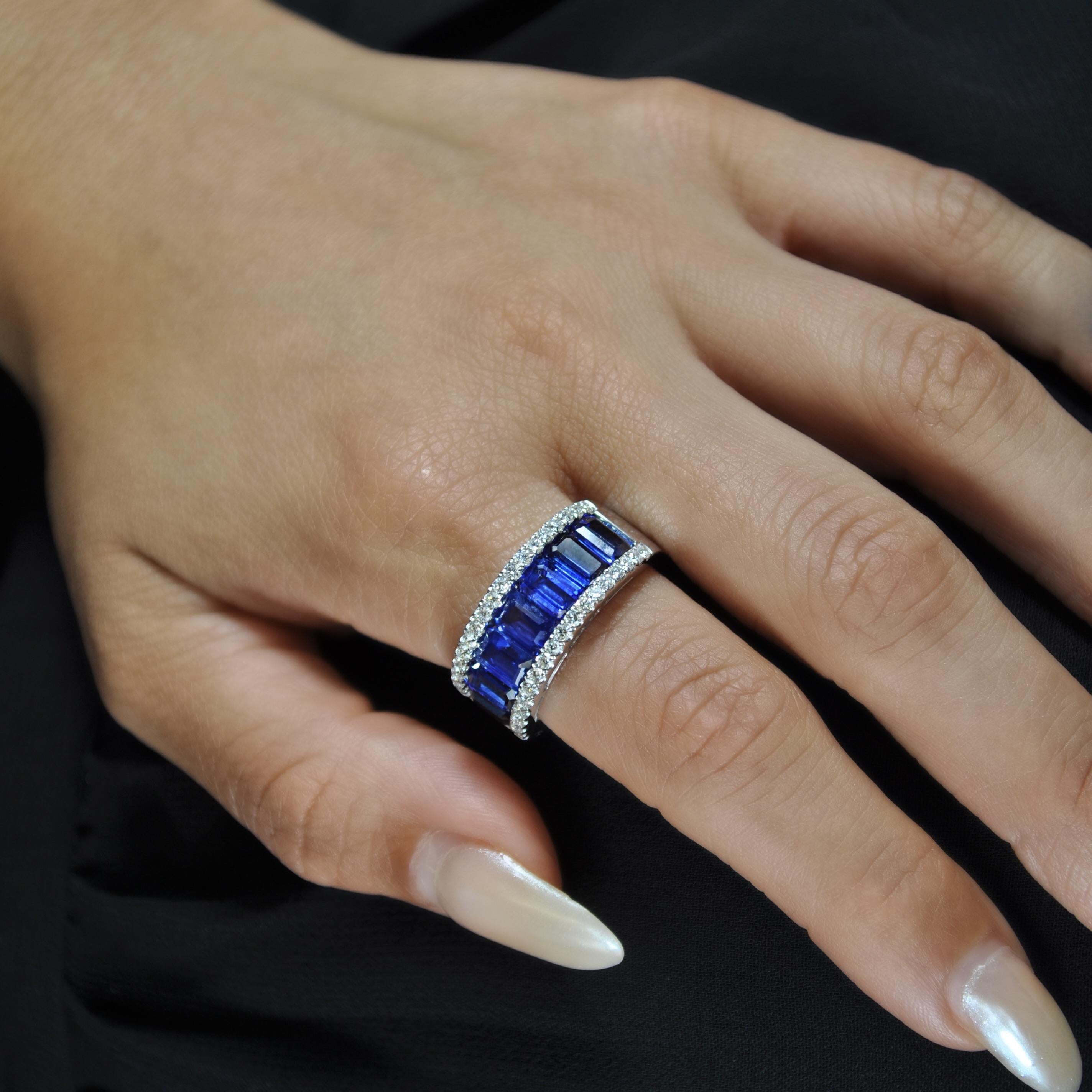 This 18k white gold cocktail ring features 4.88 carats of emerald-cut blue sapphires, with a trimming of brilliant diamonds that wraps halfway around the elegant band.

BS- 4.88 Cts
D- 0.55 Cts
All Diamonds are G-H / SI
