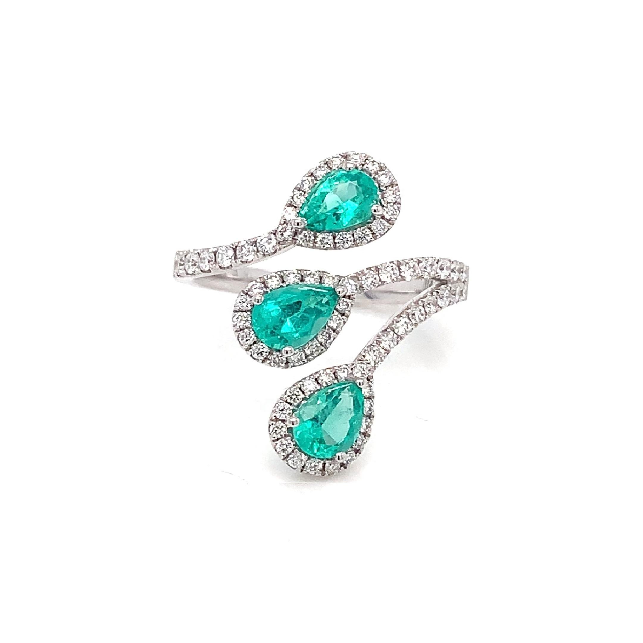 Featuring three pear-shaped emeralds surrounded by diamond halos, this bypass wrap ring is crafted from 18k white gold. Its vibrant green hues make it an ideal accessory for warm, sunny days.

18K White Gold
E-3/1.15 
D-69/0.59
