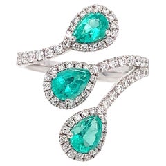 RUCHI Bypass-Ring aus Weißgold mit Smaragd und Diamant-Halo mit Bypass