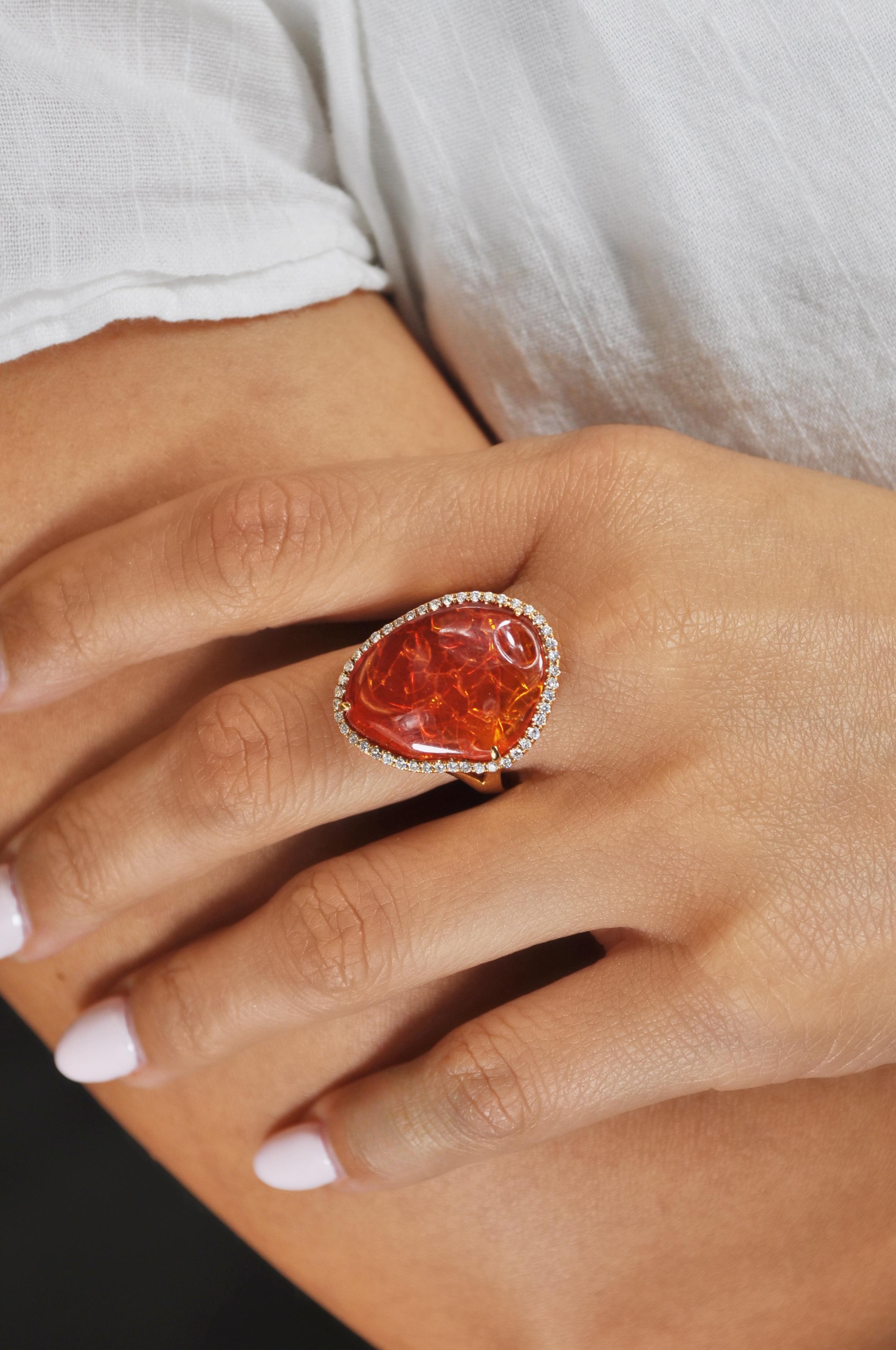 Featuring an 8.86-carat tumble-finish fire opal with a trim of diamonds, this 18k round prong rose gold cocktail ring makes the perfect statement piece.

Fire Opal: 8.86 carats
Diamonds: 0.28 carats
All the diamonds are G-H/SI