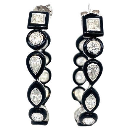 Featuring 3.48 carats of mixed-shape diamonds with a high-contrast black agate trim, these 18k white gold hoop earrings are an edgy take on a classic go-to accessory.

18K White Gold
Diamond Mix Shape - 3.48 Ct

All Diamonds are G-H/SI
