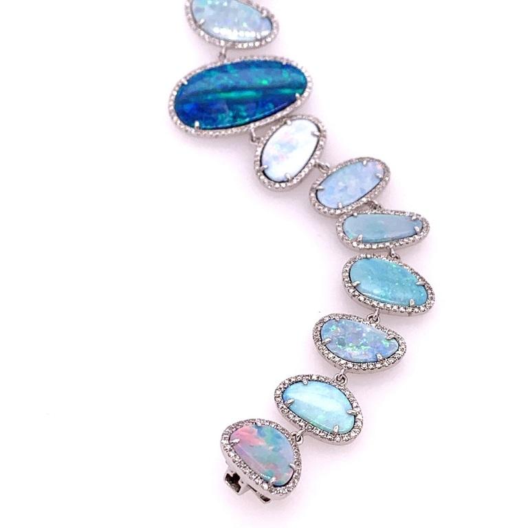 Ocean Bliss Collection

Australian Opal and Diamond bracelet set in 18k white gold. 

Australian Opal: 21.64ct total weight.
Diamonds: 1.77ct total weight.
All diamonds are G-H/SI stones.