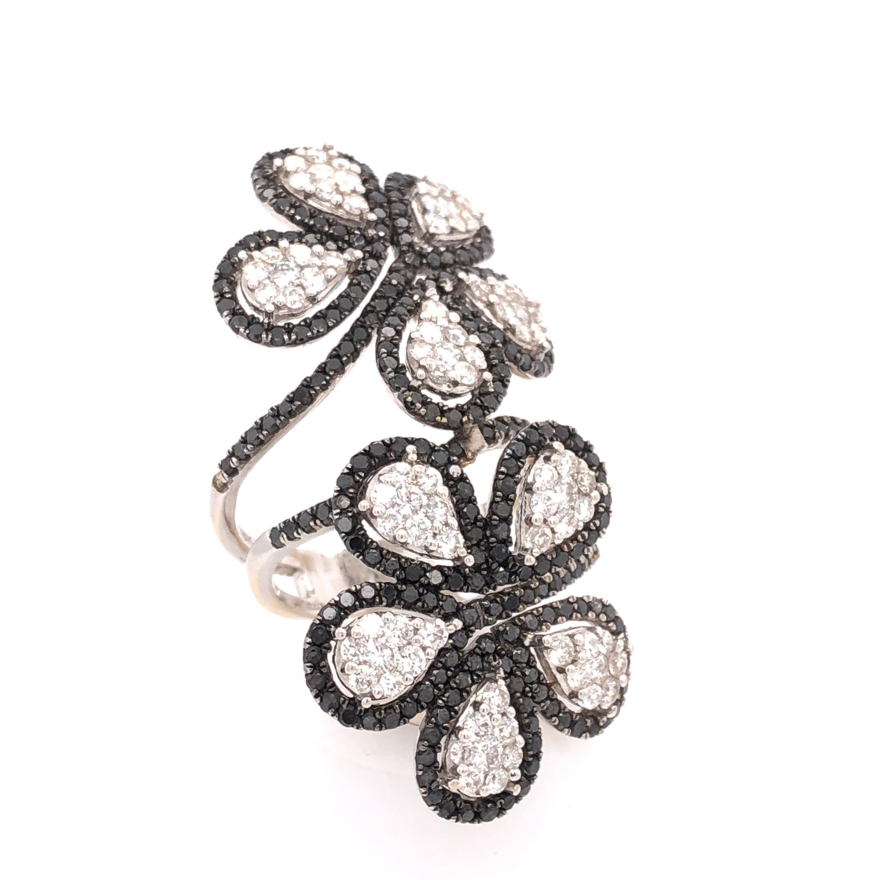 Organic Forms Collection

Black and white Diamond flower ring set in 18K white gold. 

Diamonds: 3.67ct total weight.
All diamonds are G-H/SI stones.
Height - is approximately 4.4cm/2.37inches.
Width at Bottom - is approximately 2.3cm/0.90inches.
