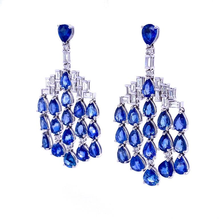 Skylight Collection

Eye catching chandelier earrings with tons of movement. Featuring pear shape blue Sapphire with round and baguette cut white Diamonds set in 18K white gold. 

Blue Sapphire: 19.87ct total weight.
Diamonds: 1.96ct total weight.