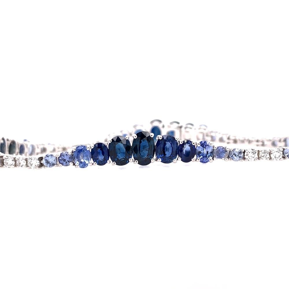 Midnight Blue Collection 

Blue Sapphire and Diamond gradient tennis style bracelet set in 18K white gold.

Blue Sapphire: 11.11ct total weight.
Diamonds: 0.39ct total weight.
All diamonds are G-H/SI stones.