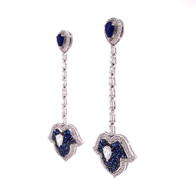 18K white gold. 
Blue Sapphire: 2.56ct total weight.
Diamonds: 1.78ct total weight.
All diamonds are G-H/SI stones.