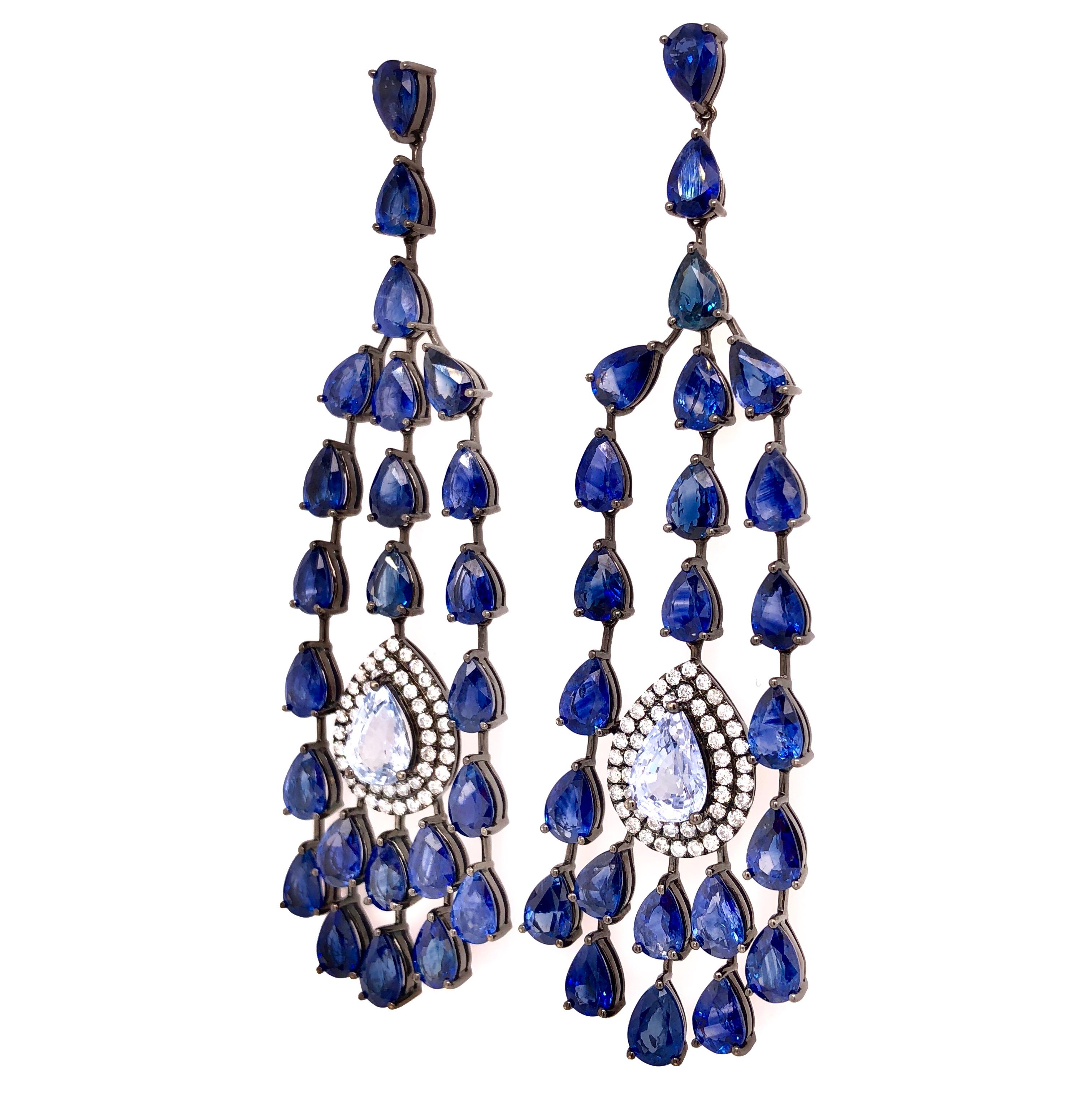 Midnight Blue Collection 

Pear shave blue Sapphire and Diamond chandelier earrings set in 18K black rhodium gold.

Blue Sapphire: 28.70ct total weight.
Diamonds: 0.75ct total weight.
All diamonds are G-H/SI stones.
Height - is approximately