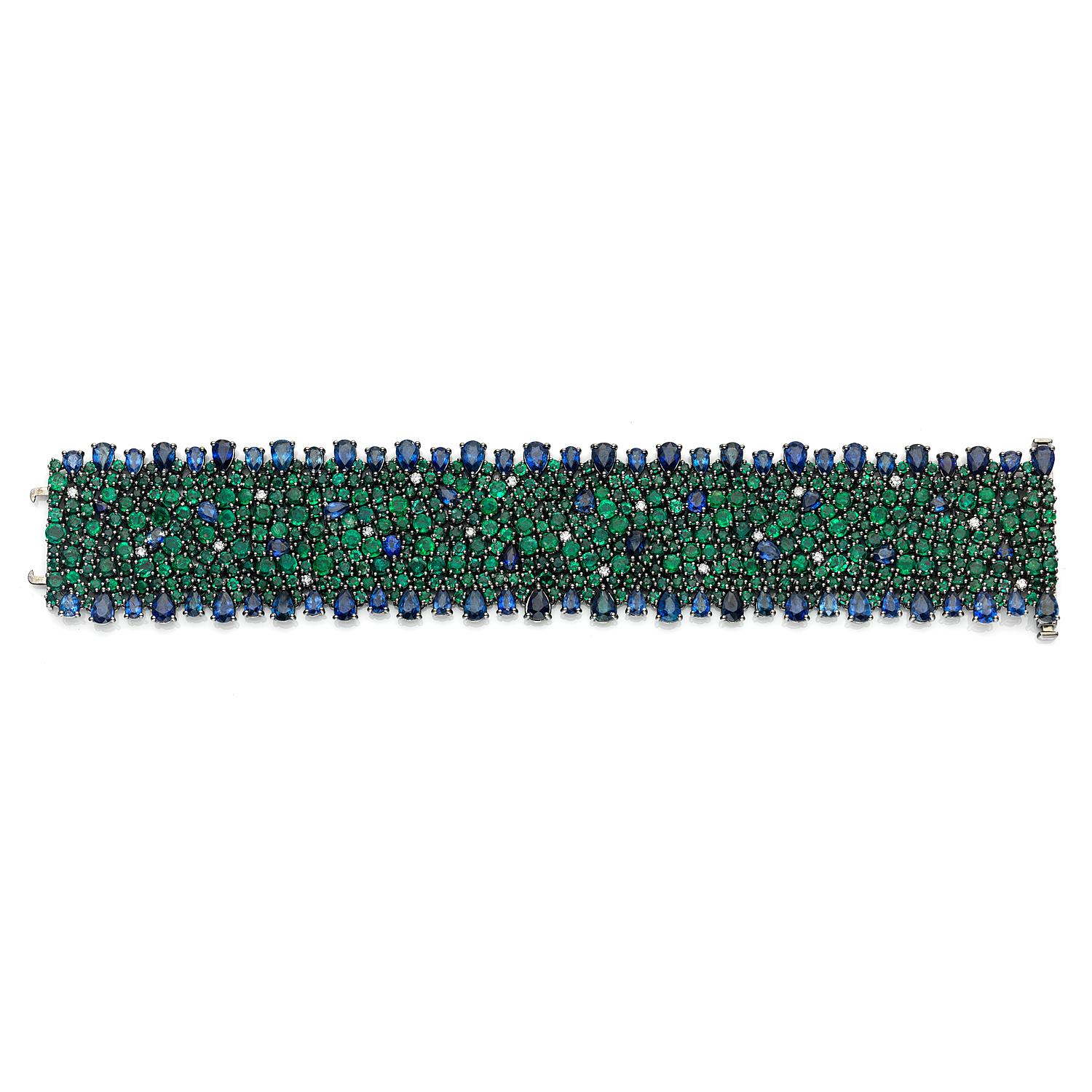 18K Tinted Black Rhodium
Blue Sapphire: 27.43ct total weight.
Emerald: 29.45ct total weight.
Diamonds: 0.57ct total weight.
All diamonds are G-H/SI stones.