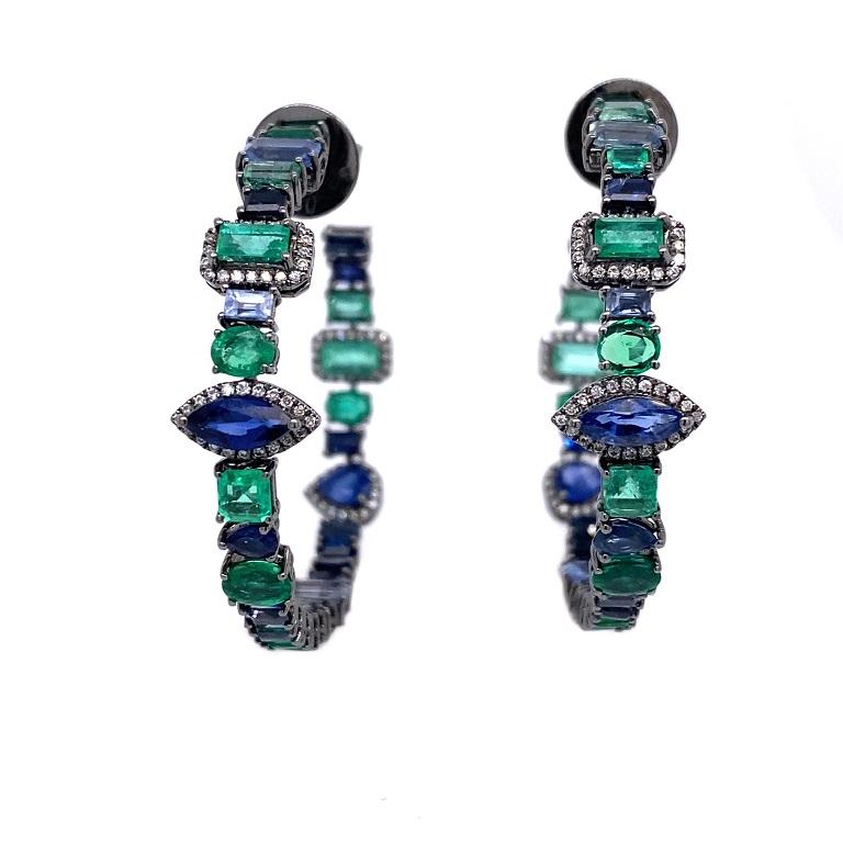 Marina Collection 

An exciting mix of shapes and sizes in these blue Sapphire, Emerald and Diamond hoop earrings. Set in 18K black rhodium gold. 

Blue Sapphire: 4.12ct total weight.
Emeralds:4.17ct total weight.
Diamonds: 0.32ct total weight.
All