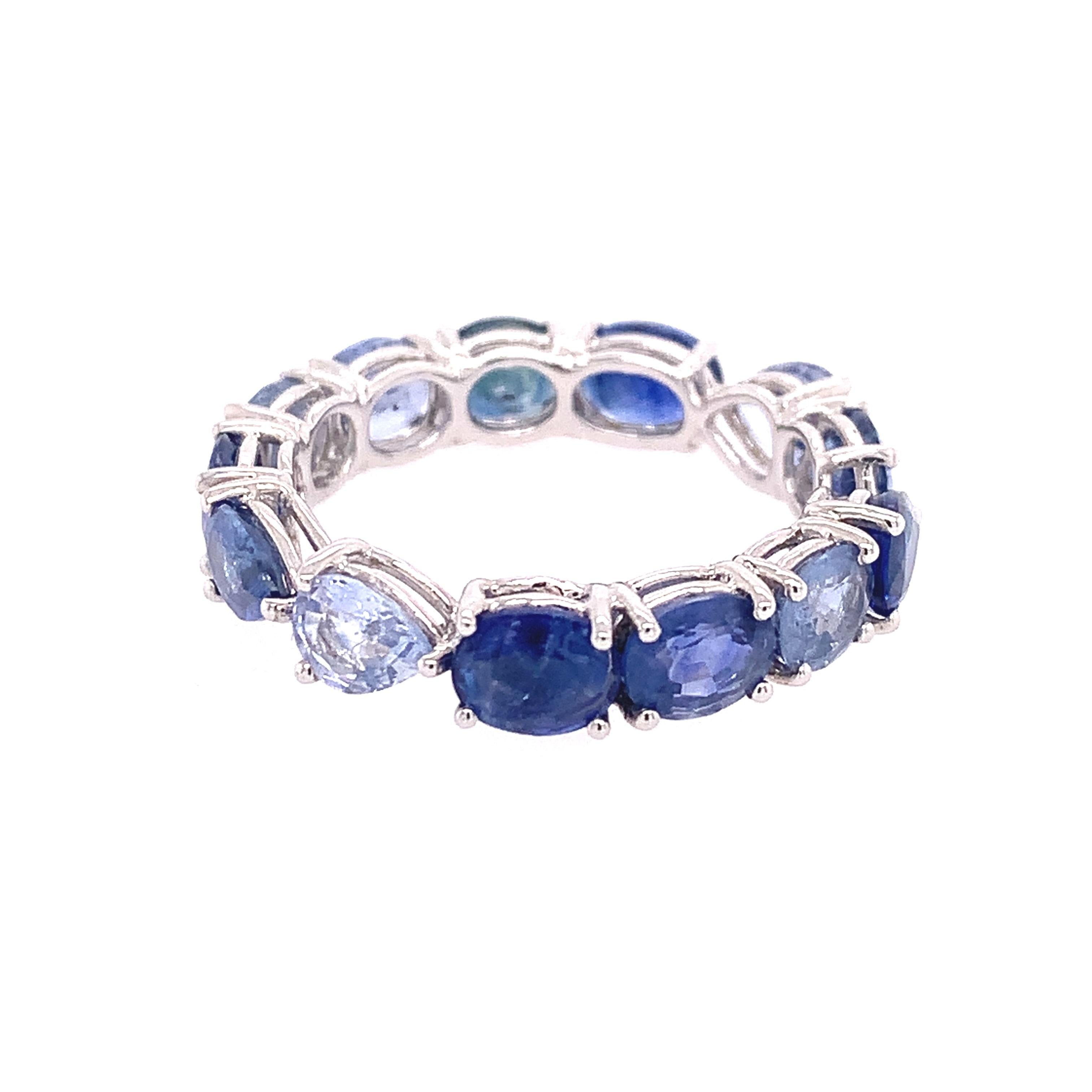 Ombre Collection,

An 18 Karat white gold eternity ring that captivates with the texture and chromatic intensity of 5.82 carats of mixed Blue Sapphire 