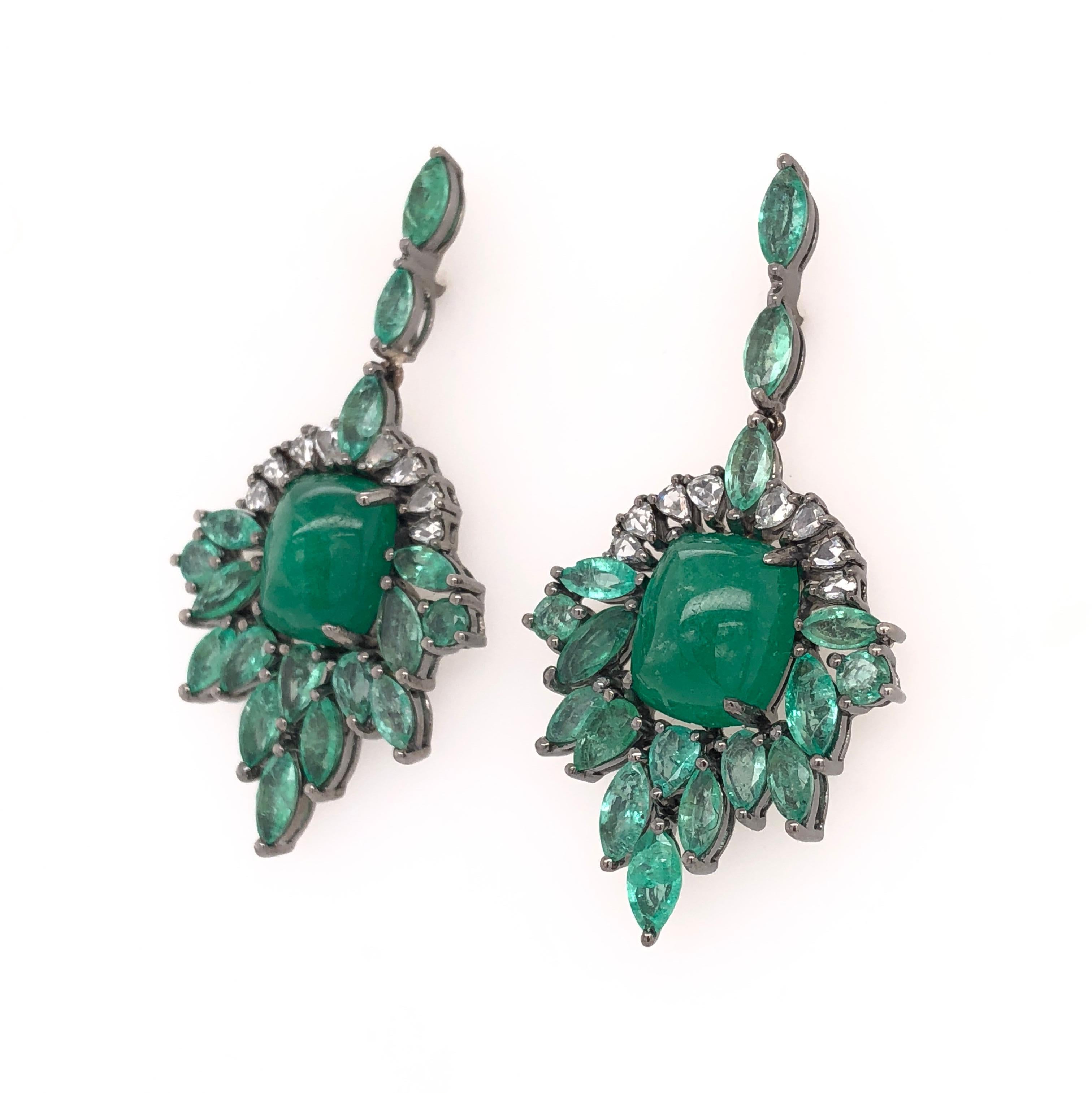 Green Lagoon Collection 

Chandelier earrings with a center Cabochon Emerald surrounded by light marquise Emeralds and rose cut pear shape diamonds set in 18K black rhodium gold. 

Emerald: 13.62ct total weight.
Diamonds: 0.54ct total weight.
All