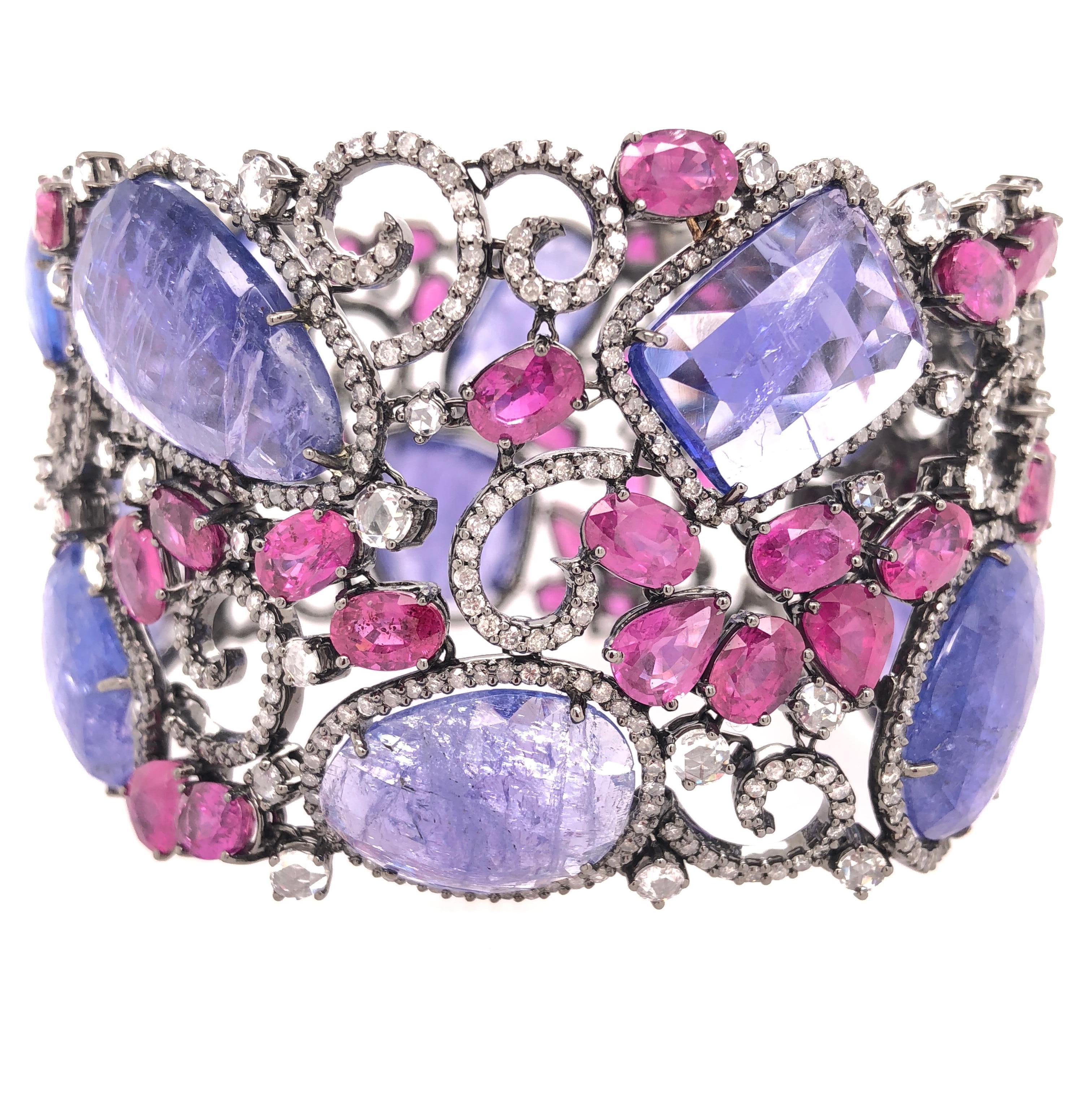Ruby Collection 

A contemporary slice Tanzanite, rose cut Diamond and multi shaped Ruby bracelet set in 18K black rhodium gold.

Tanzanite: 78.14ct total weight.
Ruby: 28.54ct total weight.
Diamond: 9.24ct total weight.
All diamonds are G-H/SI