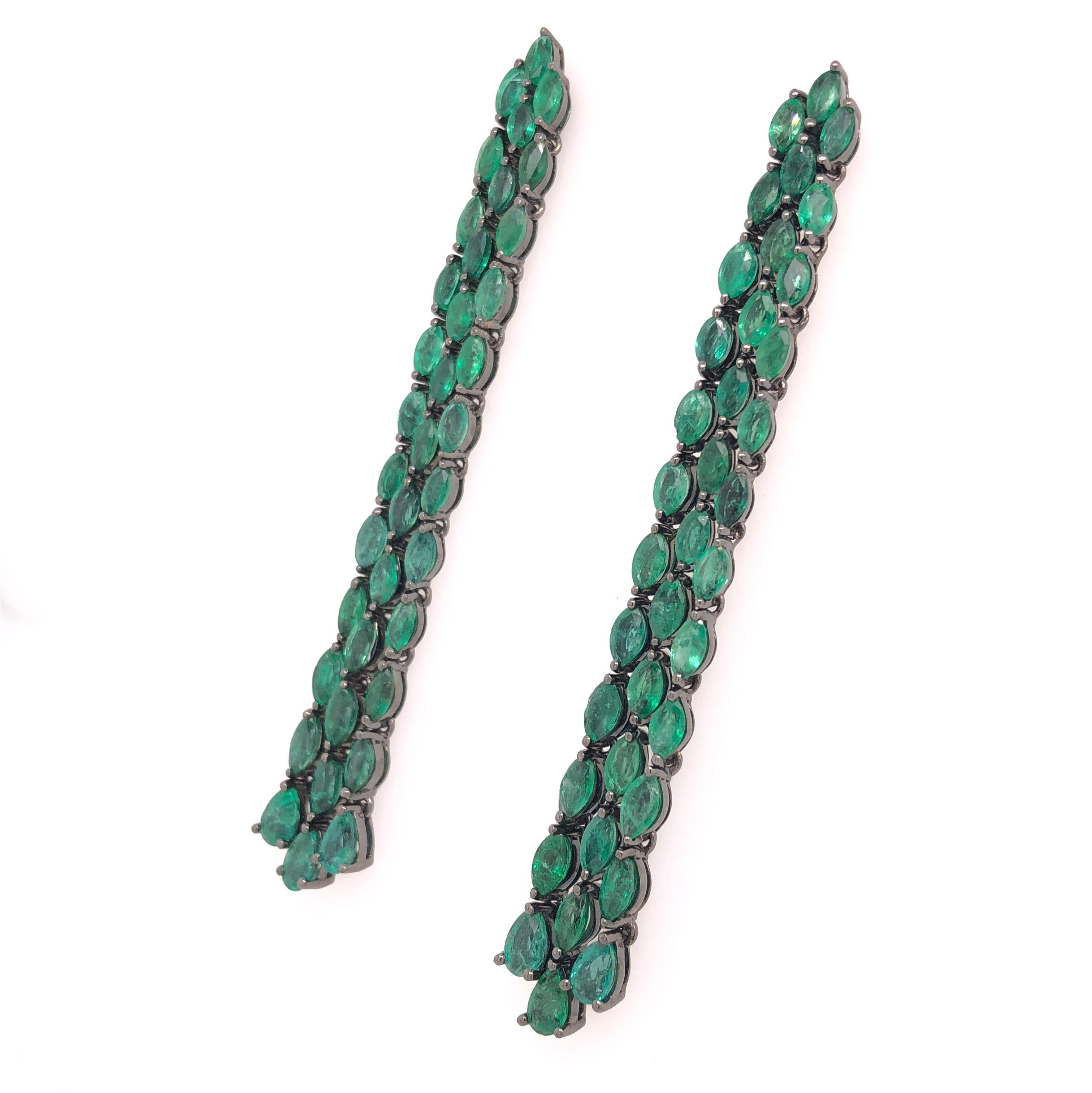 Green Lagoon Collection

Three strand flexible Emerald earrings set in 18K black rhodium gold. The earrings move easily and are lightweight.  

Emerald: 9.41ct total weight.
Height - is approximately 7cm/2.76inches.
Width - is approximately