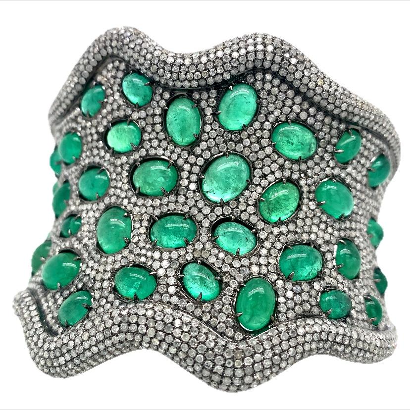 Jardin Collection

Emerald Cabochon cut Diamond Bangle in 18K black gold.

Emerald: 37.45ct total weight.
Diamond : 17.23ct total weight.
All diamonds are G-H/SI stones.