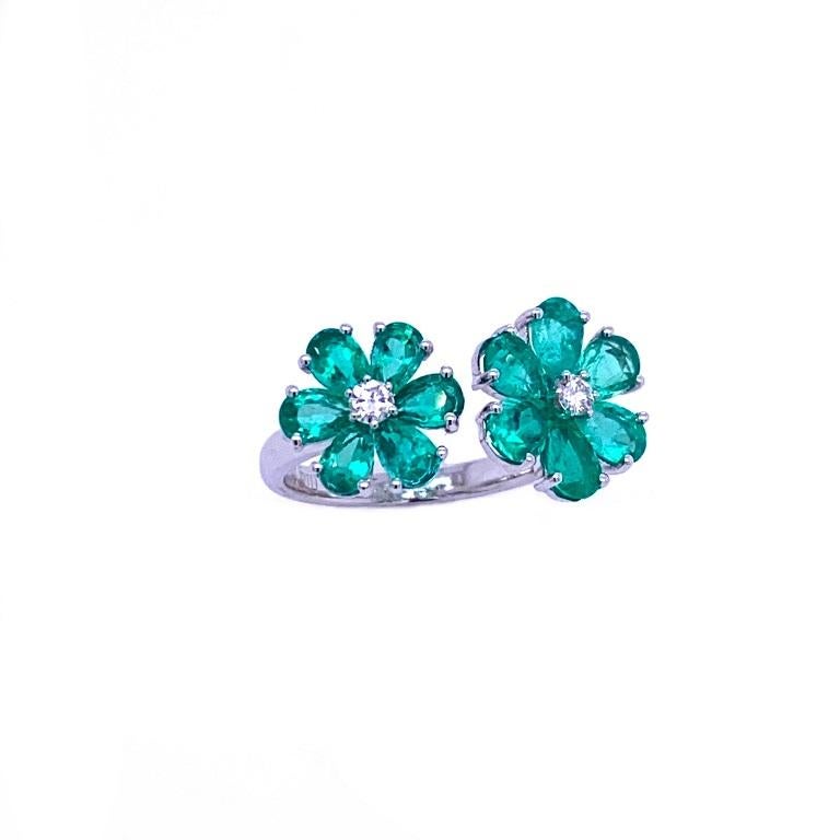 Green Lagoon Collection

Fun and flirty Emerald and Diamond open flower ring set in 18K white gold.

Emeralds: 2.67ct total weight.
Diamonds: 0.13ct total weight. 
All diamonds are G-H/SI stones.