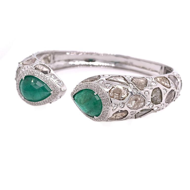 Jardin Collection

Reverse set pear shape Emeralds with Diamond slices and white rose cut Diamond accents set in 18K white gold. 

Emeralds: 10.10ct total weight. 
Diamond Slices: 8.91ct total weight.
Rose Cut Diamonds: 2.73ct total weight.
All