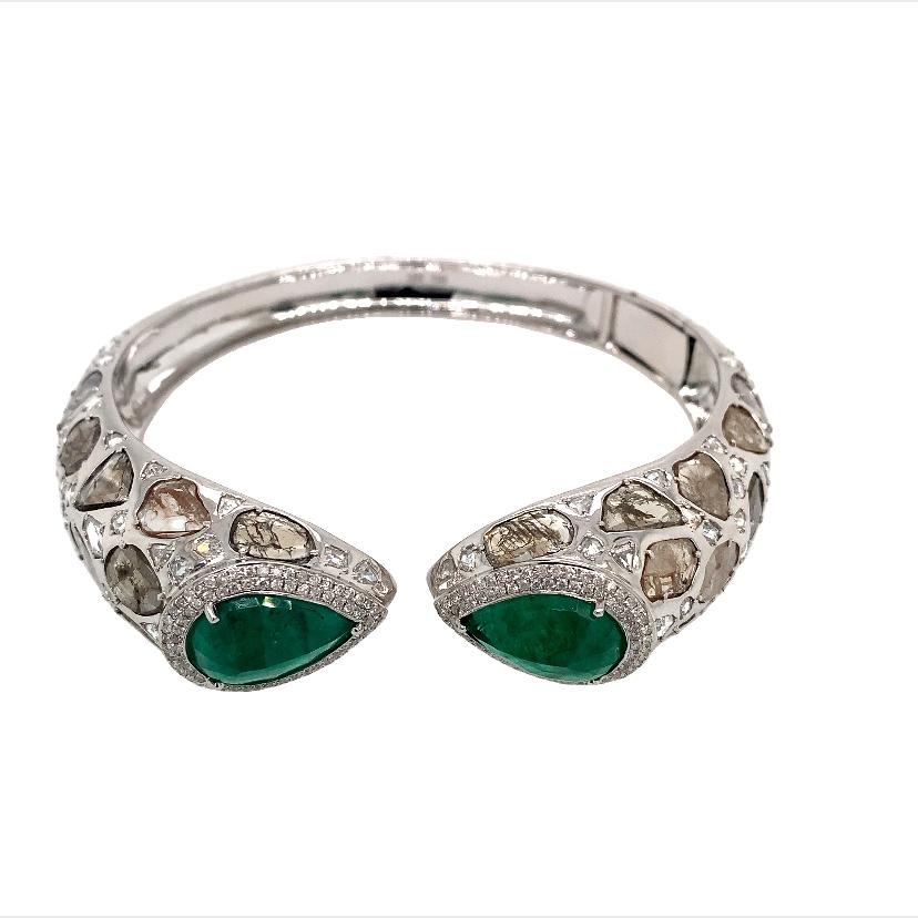 Nebula Collection

Emerald and Slice Diamond Bangle in 18K white gold.

Emerald: 10.15ct total weight.
Diamond : 11.64ct total weight.
All diamonds are G-H/SI stones.