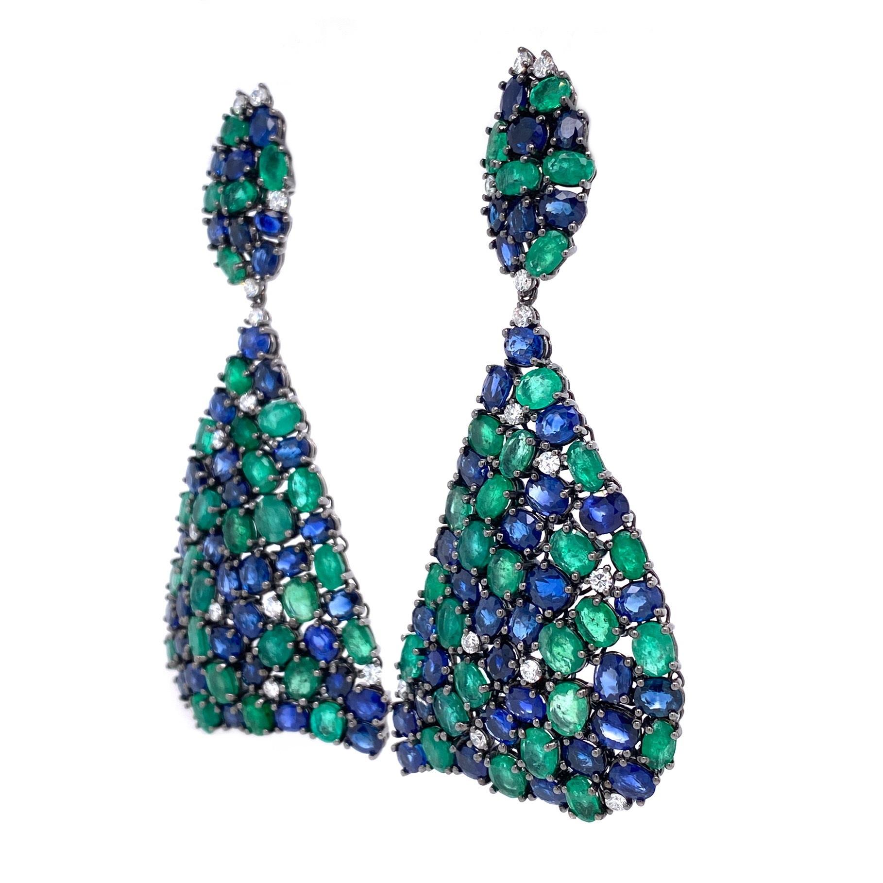 18K Black Rhodium Gold.
Emeralds: 17.42ct total weight.
Blue Sapphires: 22.30ct total weight.
Diamonds: 1.04ct total weight. 
All diamonds are G-H/SI stones.