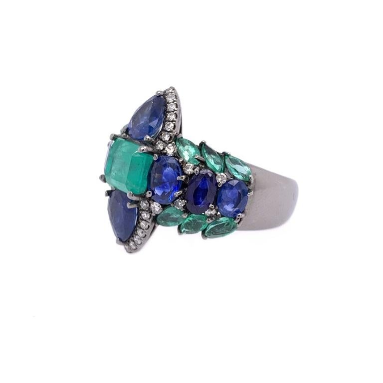 18K black rhodium gold. 
US size 6.5.
Colombian Emeralds: 2.31ct total weight.
Blue Sapphires: 3.03ct total weight..
Diamonds: 0.31ct total weight.
All diamonds are G-H/SI stones.