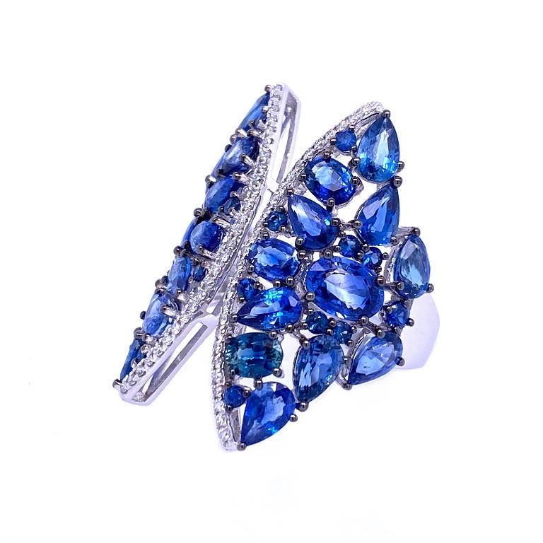 Skylight Collection

An enchanting array of different shapes in this blue Sapphire cocktail ring with Diamond accents. Set in 18K white gold. 

Blue Sapphires: 6.30ct total weight. 
Diamonds: 0.63ct total weight. 
All diamonds are G-H/SI stones.

